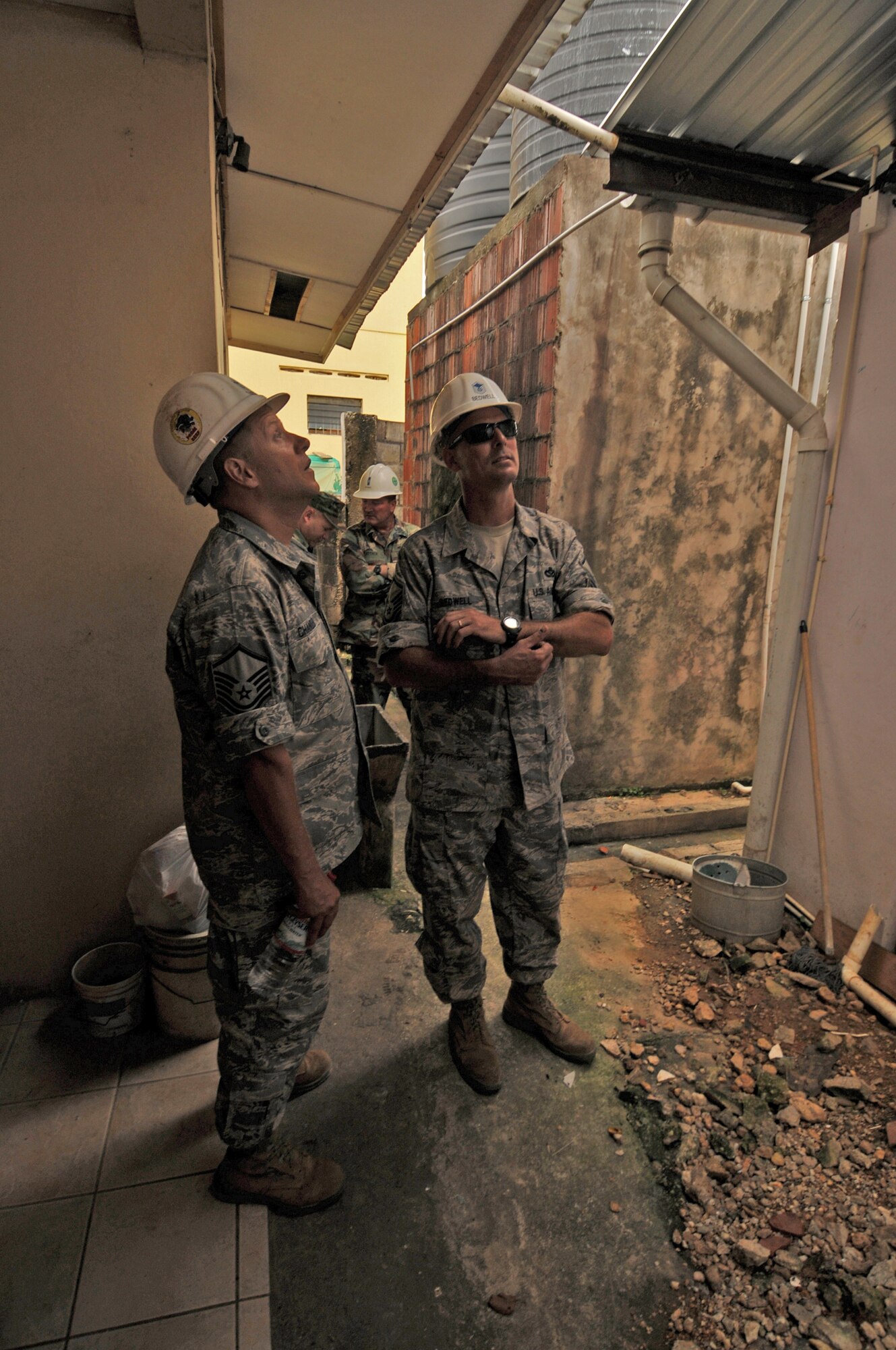 TUNAPUNA, Trinidad and Tobago -- Master Sgts. Robert Chandler and Ray Bedwell, both of the 5th Civil Engineer Squadron currently embarked aboard USS Kearsarge (LHD 3), conduct a site survey before beginning engineering operations at Cyril Ross Nursery as part of the partnership between Continuing Promise 2008 and Trinidad-Tobago. CP 2008 is a collaborative effort between the United States and partner militaries, non-governmental organizations, and partner-nation support organizations to build strong partnerships that can be called upon in the event of a regional situation requiring cooperative solutions. (U.S. Navy photo by Mass Communication Specialist 3rd Class (SW) David Danals)
