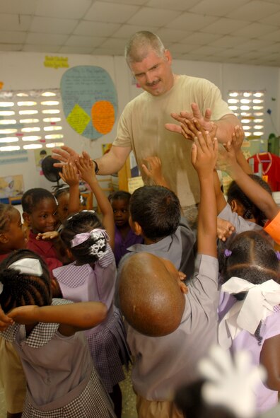 PORT OF SPAIN, Trinidad and Tobago -- Staff Sgt. Chris Nelson, 5th Civil Engineer Squadron heating, ventilation, air conditioning craftsman, currently embarked aboard USS Kearsarge (LHD 3), takes a break from renovation work at the All in One Child Development Center to entertain some of the children during Continuing Partnership (CP) 2008. CP 2008 is a collaborative effort between the United States and partner militaries, non-governmental organizations, and partner-nation support organizations to build strong partnerships that can be called upon in the event of a regional situation requiring cooperative solutions. (U.S. Navy photo by Mass Communication Specialist 2nd Class Gina Wollman)
