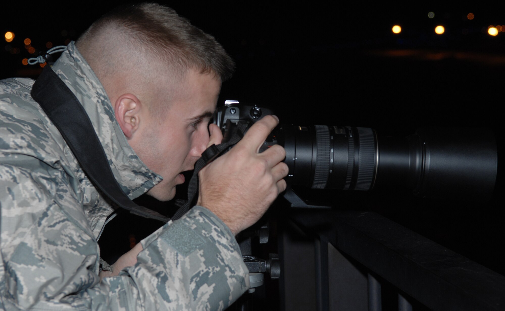 WHITEMAN AIR FORCE BASE, Mo – Airmen 1st Class Carlin Leslie, 509th Bomb Wing Public Affairs, captures images of the flight line from the air traffic control tower’s catwalk Nov. 6. The 509th Bomb Wing Public Affairs is the focal point for providing information on Whiteman issues, programs and base events to Airmen, the community and members of the news media. The staff conducts base tours, provides speakers for civic organizations in the community, and is the commander's liaison between the base and media organizations. All media requests concerning Whiteman people, programs and events must be coordinated through Public Affairs.  (U.S. Air Force photo/Senior Airman Stephen Linch)