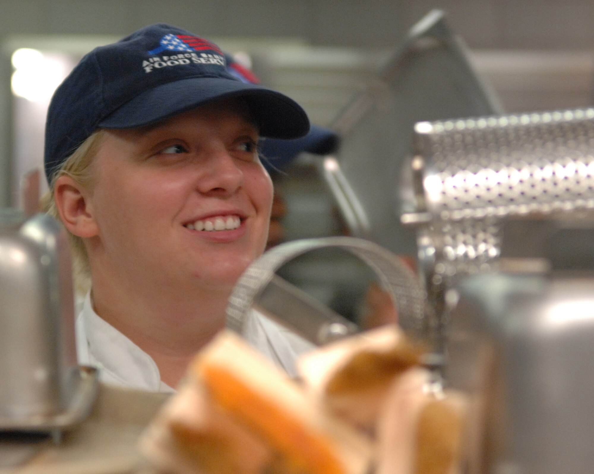 WHITEMAN AIR FORCE BASE, Mo – Airmen 1st Class Courtney Robinson, 509th Force Support Squadron, works late into the night at the Ozark Inn putting up cooking utensils Nov. 6.  The Ozark Inn accommodates more than 250 people at one time. Breakfast, lunch, dinner and a midnight meal are served daily. Highlighting the dining options are a well-stocked salad bar, hot and cold sandwiches, special entrees and homemade pastries. Family dining options are extended to junior enlisted members and their families who are just arriving or soon to depart, as well as to family members whose spouses are deployed. The Ozark Inn serves breakfast 6 - 8:30 a.m., lunch 11 a.m. - 1p.m., dinner 5 - 8 p.m., midnight 11 p.m. - 12:30 a.m. during the week and brunch 7 a.m. - 12:30 p.m., dinner 6 - 8 p.m. and midnight 11 p.m. - 12:30 a.m. on holidays and the weekend. (U.S. Air Force photo/Senior Airman Stephen Linch)