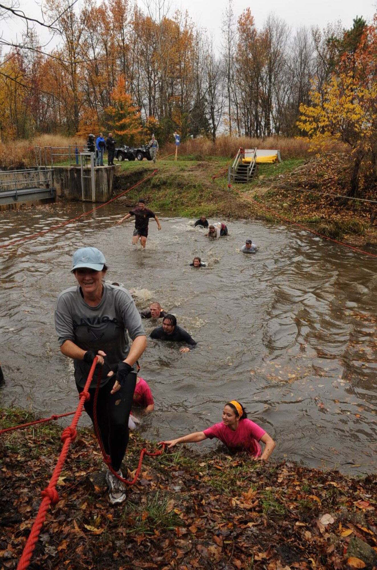 Participants who were able to traverse the cold water in a creek were confronted with a rope-climb up a slippery hill Nov. 8 during the first McGuire Mud Run. The Burlington County Military Affairs Committee, along with 305th Civil Engineer Squadron, designed the 10K course at McGuire to be both challenging and fun for runners. More than 1,000 people participated in the event. (U.S. Air Force photo/Capt. Darrick Lee)