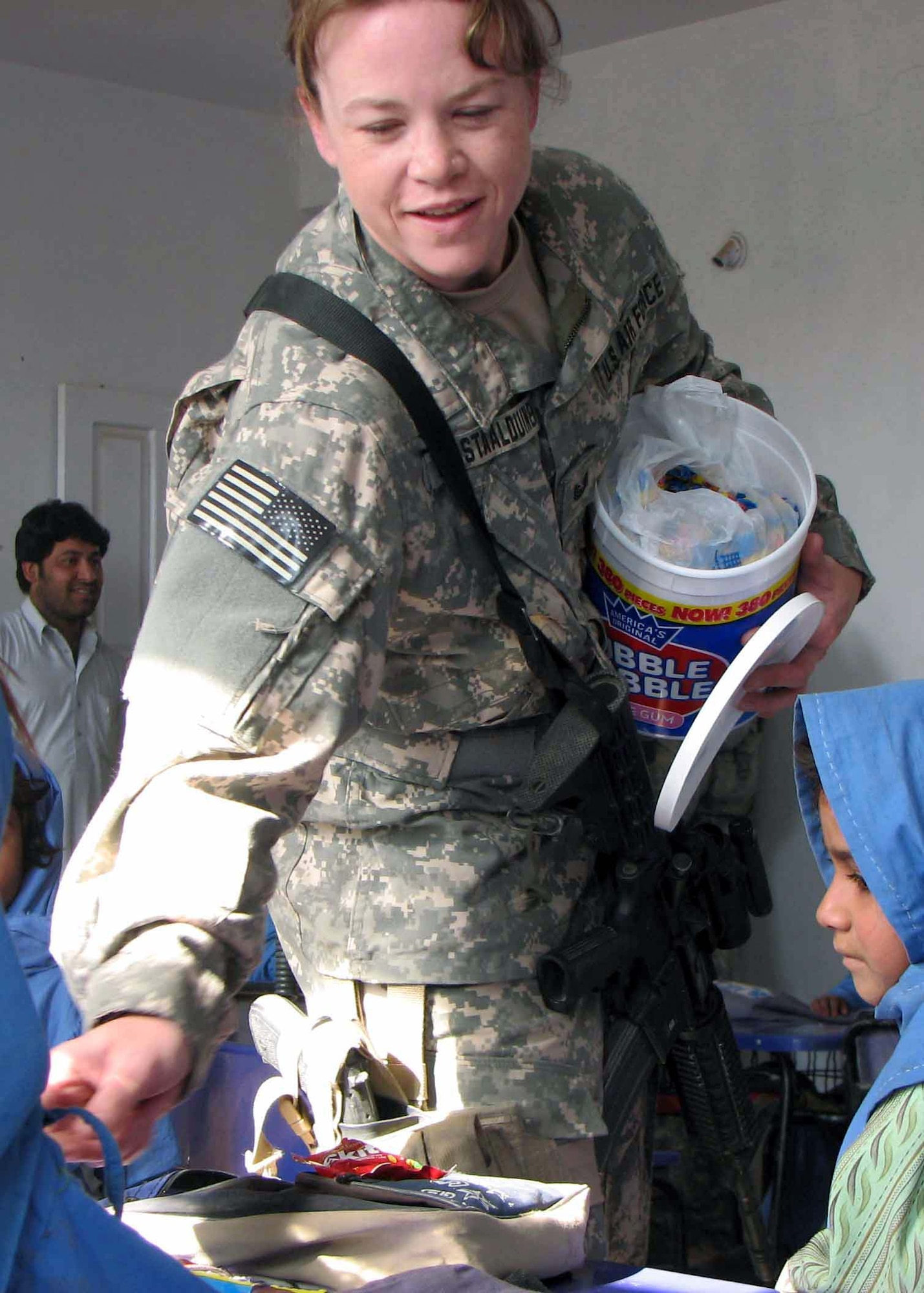 Tech. Sgt. Chandra Van Staalduinen passes out candy to children in the Hope of Mother School Nov. 8 in the Nangarhar Province of Afghanistan. She is part of the Nangarhar Provincial Reconstruction Team that is made up of Airmen and Soldiers charged with assisting the provincial government in improving security, governance and reconstruction. Sergeant Van Staalduinen is a native of Mayodan, N.C., and assigned to the 366th Communications Squadron, Mountain Home Air Force Base, Idaho. (U.S. Air Force photo/Capt. J. Elaine Hunnicutt) 
