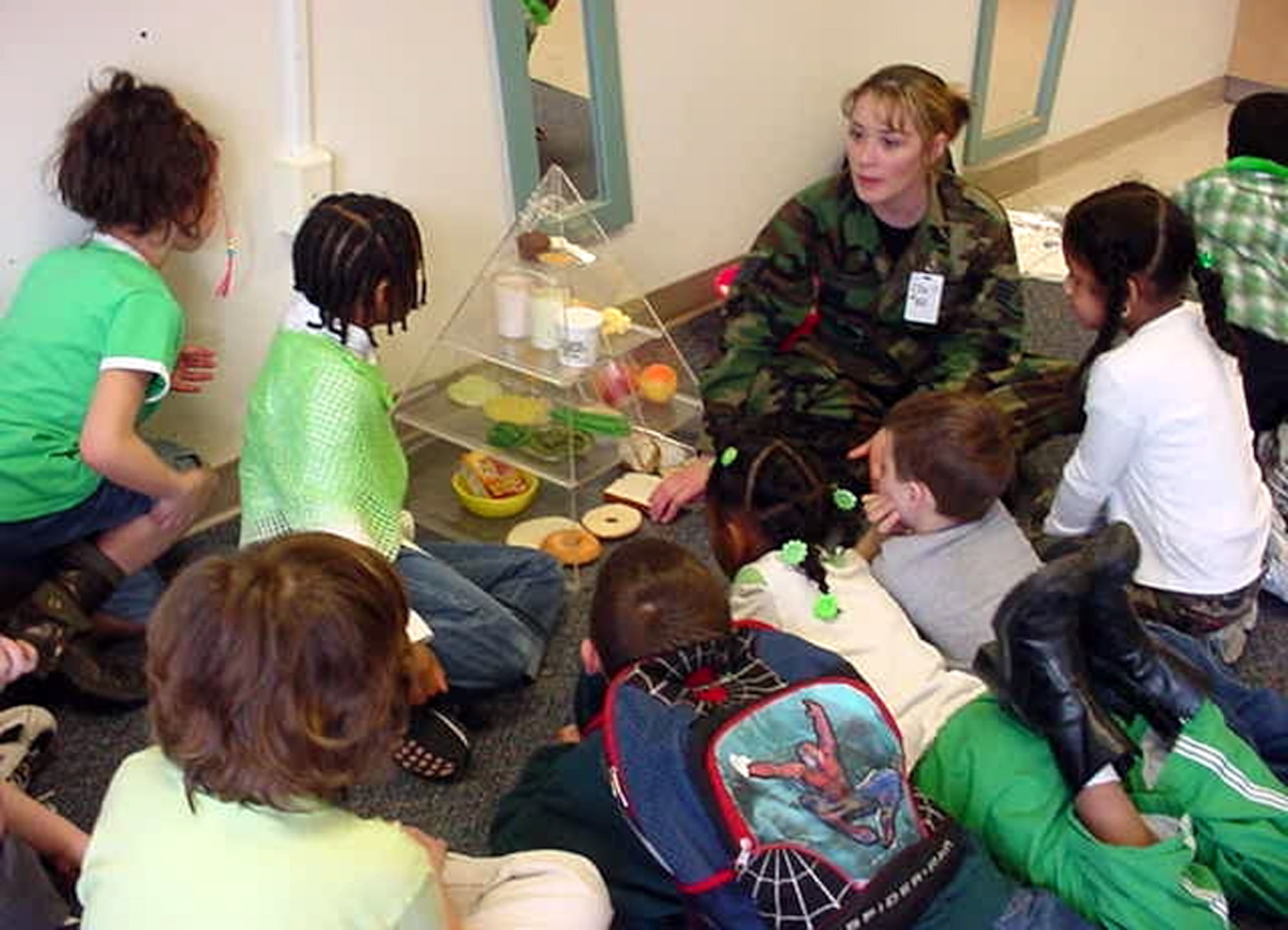 A HAWC staff member educates children on basic nutrition with the food pyramid during a summer session with DEFY, which is run by McGuire’s Drug Demand and Reduction office. The HAWC staff is available to provide fitness and nutrition information to all Team McGuire members, including retirees and family members. (U.S. Air Force courtesy photo)