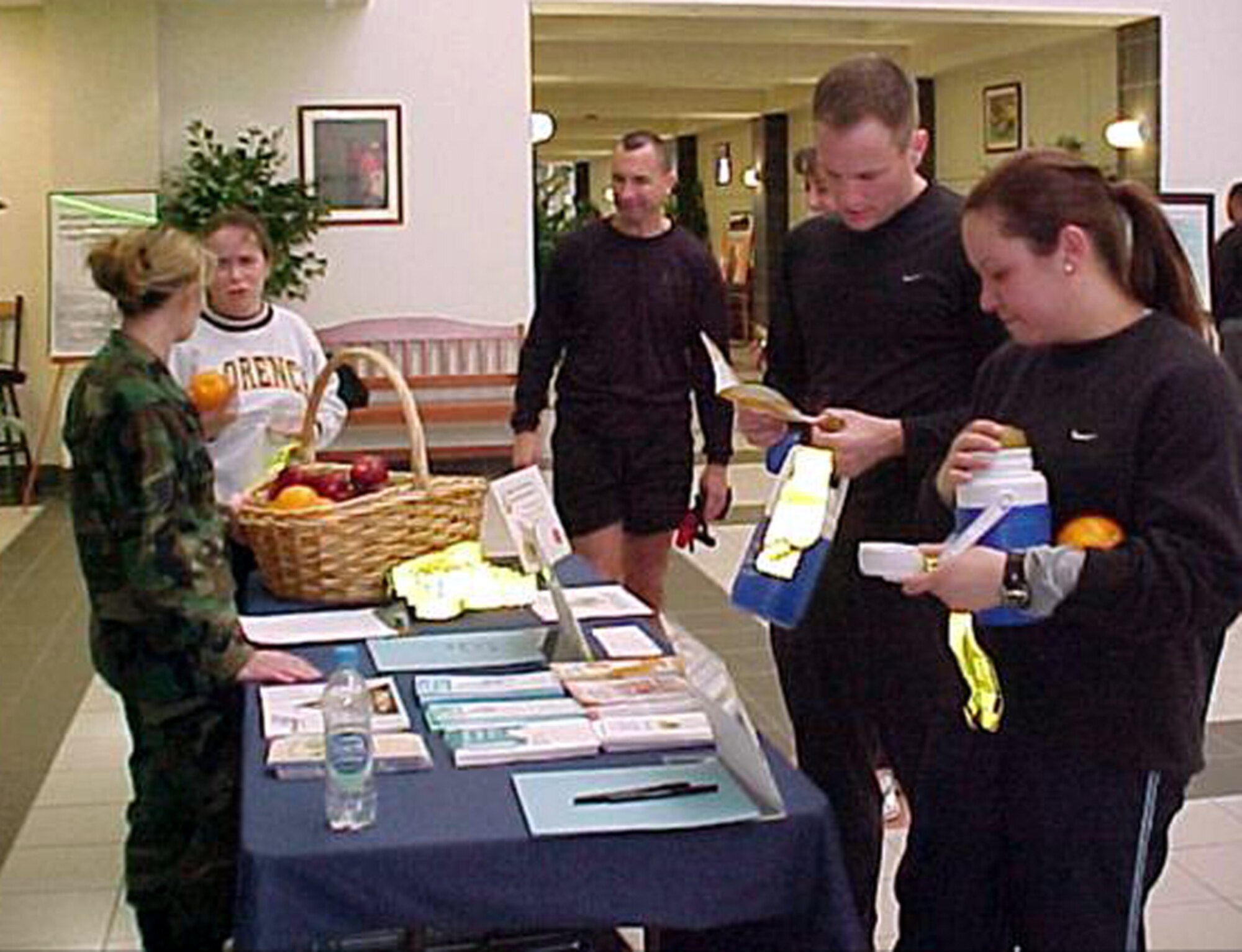A Health and Wellness Center staff member gives out educational information and fruit during National Nutrition Month in March. The HAWC staff works year-round to spread information about eating healthy and being fit. (U.S. Air Force courtesy photo)