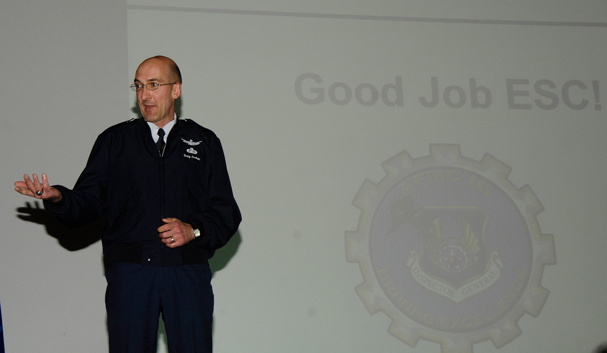 Brig. Gen. Terry Feehan, Electronic Systems Center vice commander, presents the results of the recent Unit Compliance Inspection and Targeted Readiness Inspection at the Hanscom Base Theater Nov. 10.