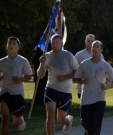 Airmen from the 437th Logistics Readiness Squadron sprint to the finish line with their guidon during the Commander's Fitness Challenge on Charleston AFB Nov. 7. More than 400 Airmen from various squadrons came out to participate in the monthly challenge. (U.S. Air Force photo/Senior Airman Timothy Taylor)
