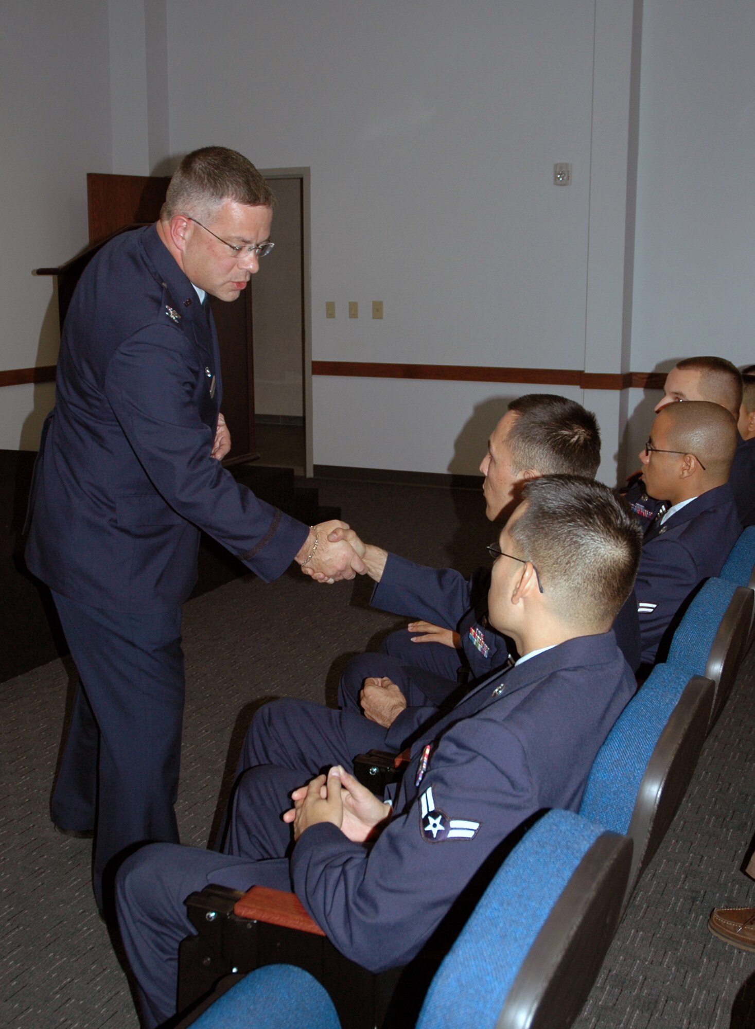 DOVER AIR FORCE BASE, Del. -- 512th Airlift Wing Commander Col. Randal L. Bright congratulates eight of America's newest citizens on Veterans Day, Nov. 11. Eight 436th Airlift Wing Airmen, who hailed from seven countries, raised their right hands and said the Oath of Allegiance during the Military Naturalization Ceremony here.(U.S. Air Force photo/Capt. Marnee A.C. Losurdo)