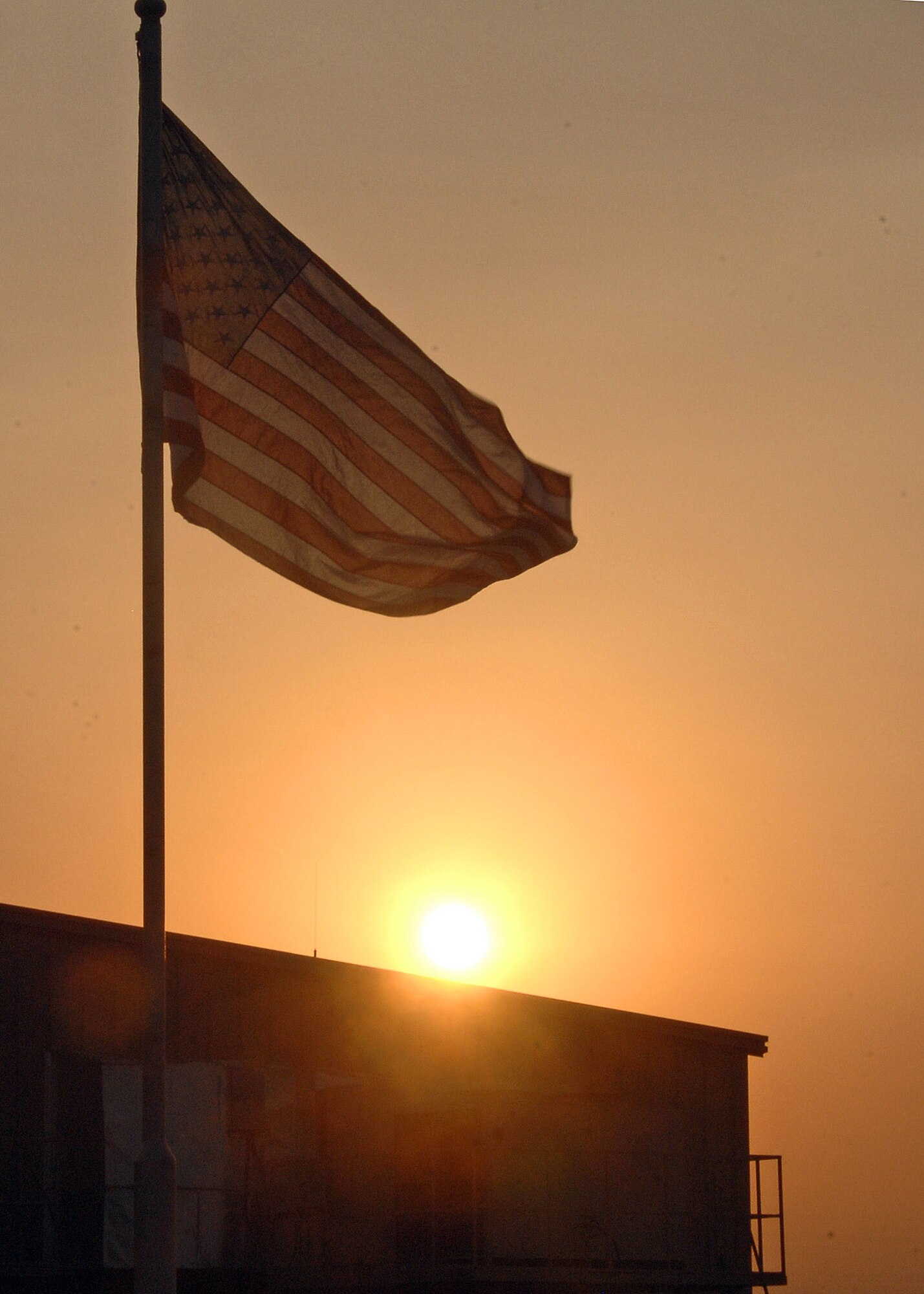 The American flag is raised during the 386th Air Expeditionary Wing Veterans Day Reveille Ceremony Nov. 11 at an air base in Southwest Asia. (U.S. Air Force photo/Tech. Sgt. Raheem Moore) 
