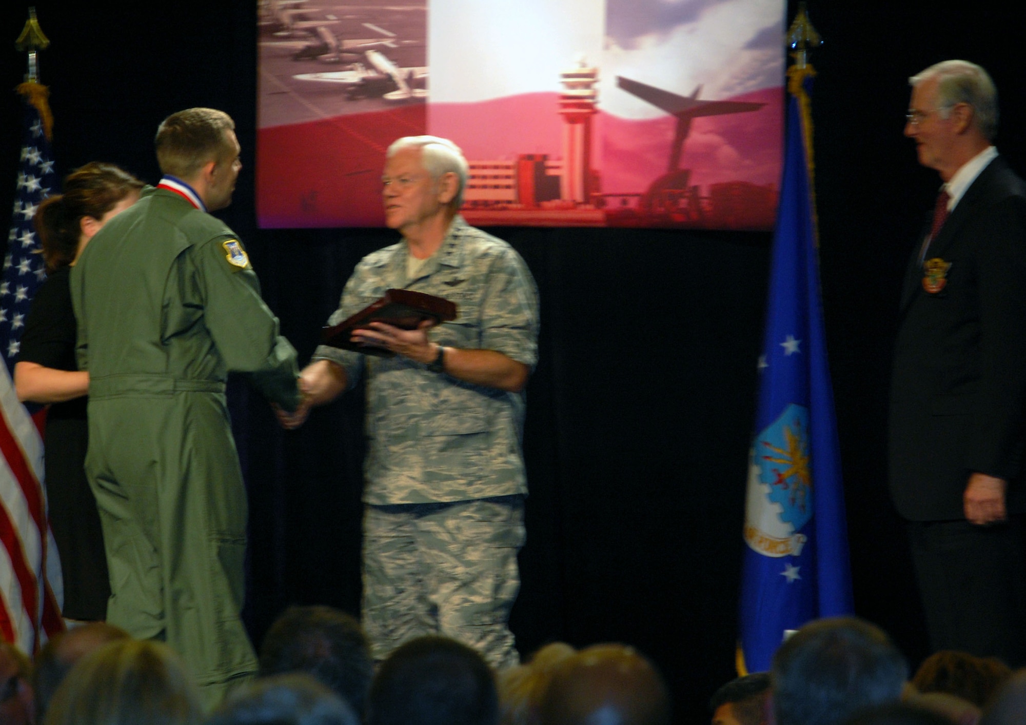 Tech. Sgt. Jeremiah Love, from the 618th Tanker Airlift Control Center at Scott Air Force Base, Ill., and formerly with the 32nd Air Refueling Squadron at McGuire AFB, N.J., receives the 2008 Airlift/Tanker Association Young Leadership Award placque from Gen. Arthur Lichte, Air Mobility Command commander, during an awards presentation at the 2008 A/TA convention in Anaheim, Calif., Nov. 7.  Sergeant Love is a KC-10 evaluator in-flight refueling operator who was nominated for the award while stationed at McGuire.  (U.S. Air Force Photo/Tech. Sgt. Scott T. Sturkol)