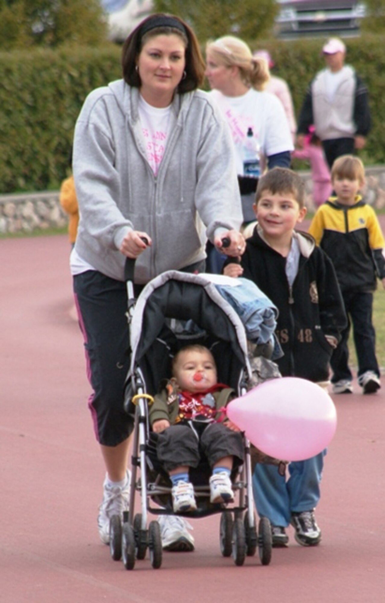 Melanie Huk, wife of Senior Master Sgt. Edward Huk, 31st Communications Squadron, and her sons participate in the Aviano Community Enlisted Spouses Club Breast Cancer Awareness Walk Sept. 27. Mrs. Huk was recently named the Joan Orr Air Force Spouse of the Year. (U.S. Air Force photo)