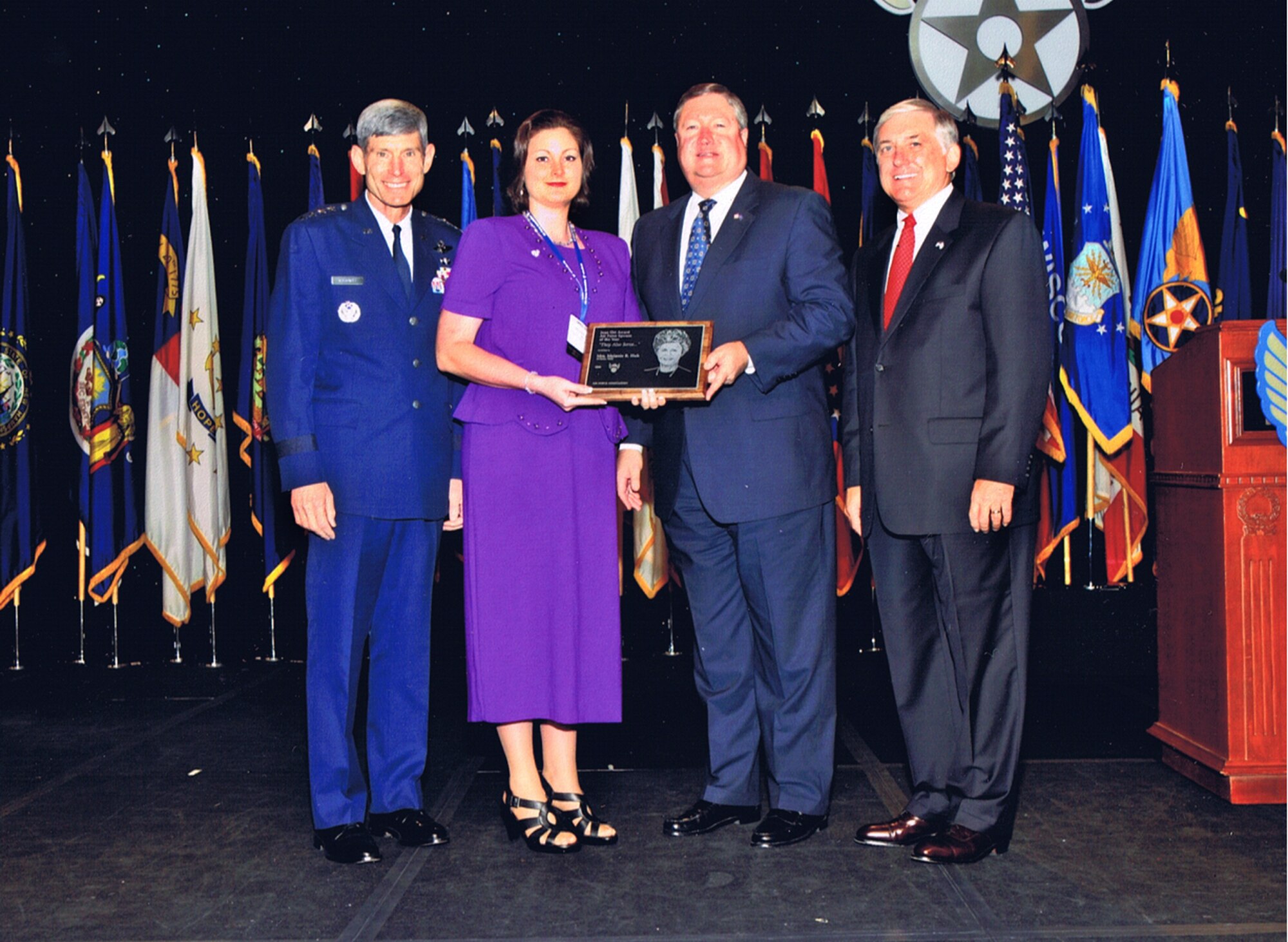 Gen. Norton Schwartz, Air Force Chief of Staff; Michael Donley, Secretary of the Air Force and Robert Largent, (right) Air Force Association Chairman of the Board, present Melanie Huk, wife of Senior Master Sgt. Edward Huk of the 31st Communications Squadron with the Joan Orr Air Force Spouse of the Year award during a special ceremony in Washington D.C. on Sept. 15. (U.S. Air Force photo)