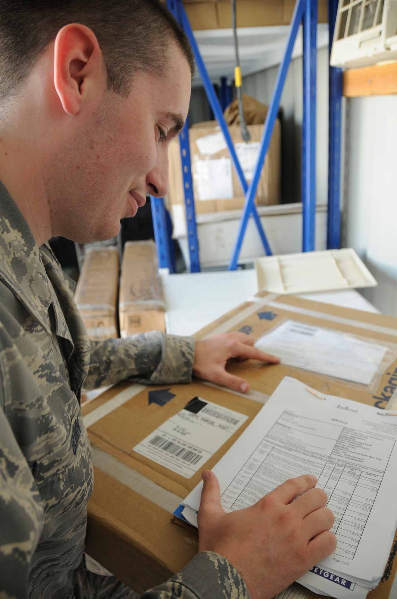 Senior Airman Jordan Gunn, contracting officer assigned to the 379th Expeditionary Contracting Squadron, checks the product number to ensure it is what the customer ordered before accepting and paying the invoice Nov. 11, at an undisclosed air base in Southwest Asia.  Airman Gunn, a native of Anchorage, Alaska, is deployed from Charleston Air Force Base, S.C., in support of Operations Iraqi and Enduring Freedom and Joint Task Force-Horn of Africa. (U.S. Air Force photo by Staff Sgt. Darnell T. Cannady/Released)