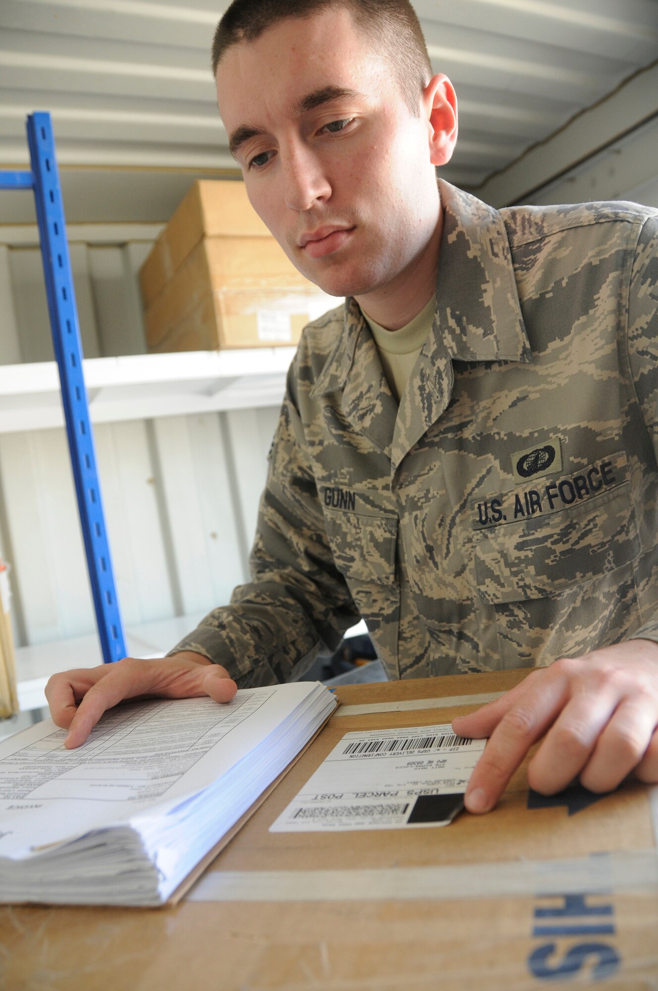 Senior Airman Jordan Gunn, contracting officer assigned to the 379th Expeditionary Contracting Squadron, checks the product number to ensure it is what the customer ordered before accepting and paying the invoice Nov. 11, at an undisclosed air base in Southwest Asia.  Airman Gunn, a native of Anchorage, Alaska, is deployed from Charleston Air Force Base, S.C., in support of Operations Iraqi and Enduring Freedom and Joint Task Force-Horn of Africa. (U.S. Air Force photo by Staff Sgt. Darnell T. Cannady/Released)