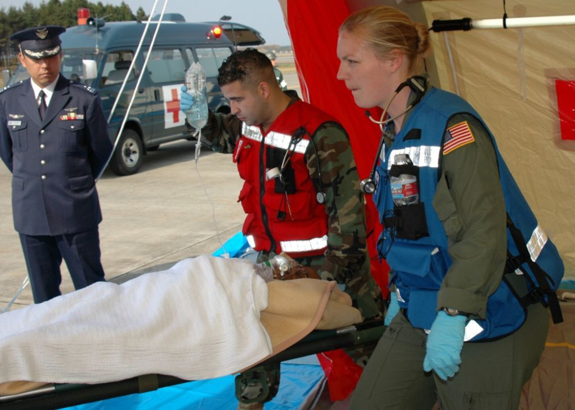 MISAWA AIR BASE, Japan -- Petty Officer 2nd Class Angel Vicente and Navy Lt. Christa Thomasma, Naval Air Facility Misawa, carry a simulated patient to a waiting ambulance, during an aircraft mishap exercise held at nearby Misawa Airport, Nov. 6, 2008. The annual exercise involved fire and medical personnel from the U.S. Air Force, U.S. Navy, Japan Air Self-Defense Force, and emergency first responders from the local Japanese area. (U.S. Navy photo by Chief Petty Officer Brian Naranjo)


