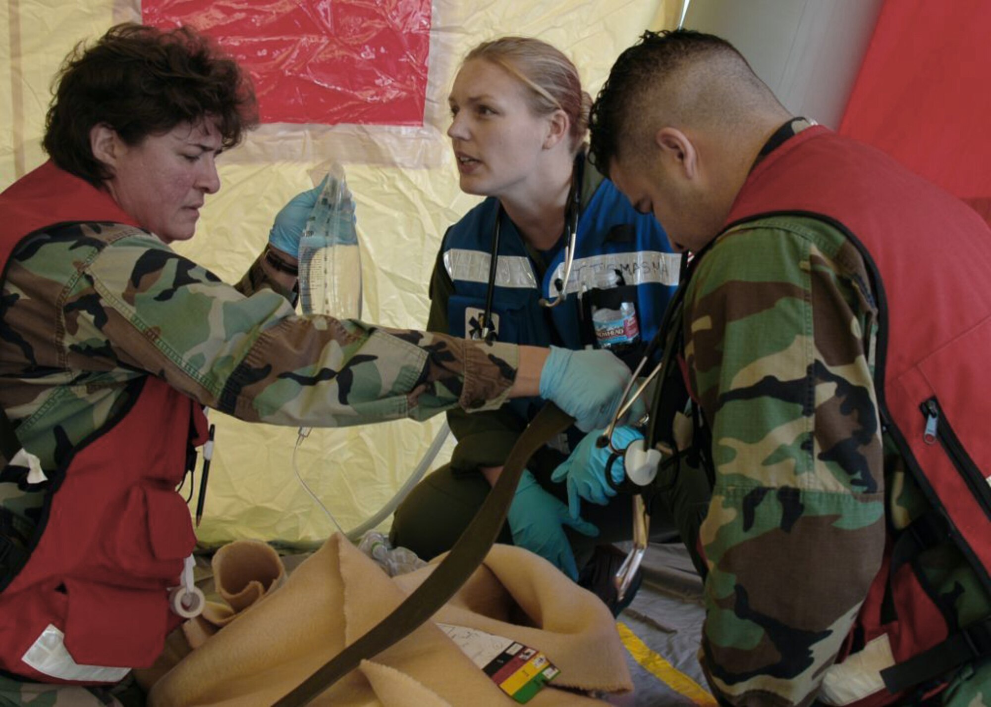 MISAWA AIR BASE, Japan -- Petty Officer 1st Class Lisa Hovde, Naval Air Facility Misawa, holds an intravenous drip bag over a simulated patient, while Navy Lt. Christa Thomasma, Naval Air Facility Misawa, gives instructions during an aircraft mishap exercise held at nearby Misawa Airport Nov. 6, 2008. The annual exercise involved fire and medical personnel from the Air Force, Navy, Japan Air Self-Defense Force, and emergency first responders from the local Japanese area. (U.S. Navy photo by Chief Petty Officer Brian Naranjo)