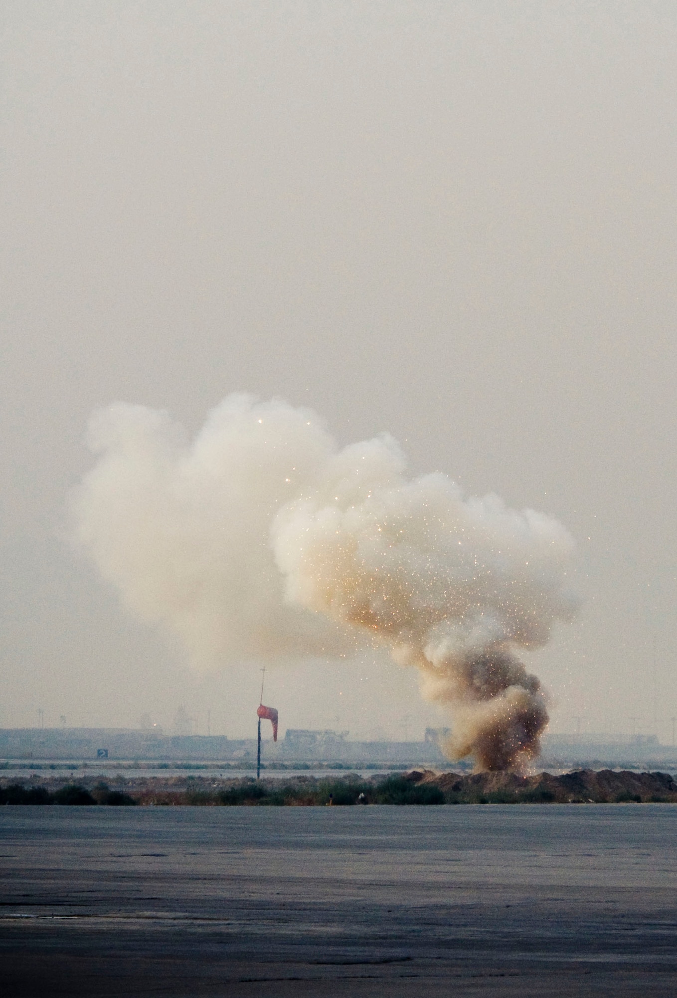 Sparks fly as a thermite grenade burns through an old OFAB 100 Soviet bomb on the flightline at Bagram Air Field, Afghanistan, Nov. 7. Personnel and aircraft were evacuated to a safe distance just in case there was a full-sized detonation, but in this case, that proved unnecessary. (U.S. Air Force photo by Staff Sgt. Samuel Morse/Released)