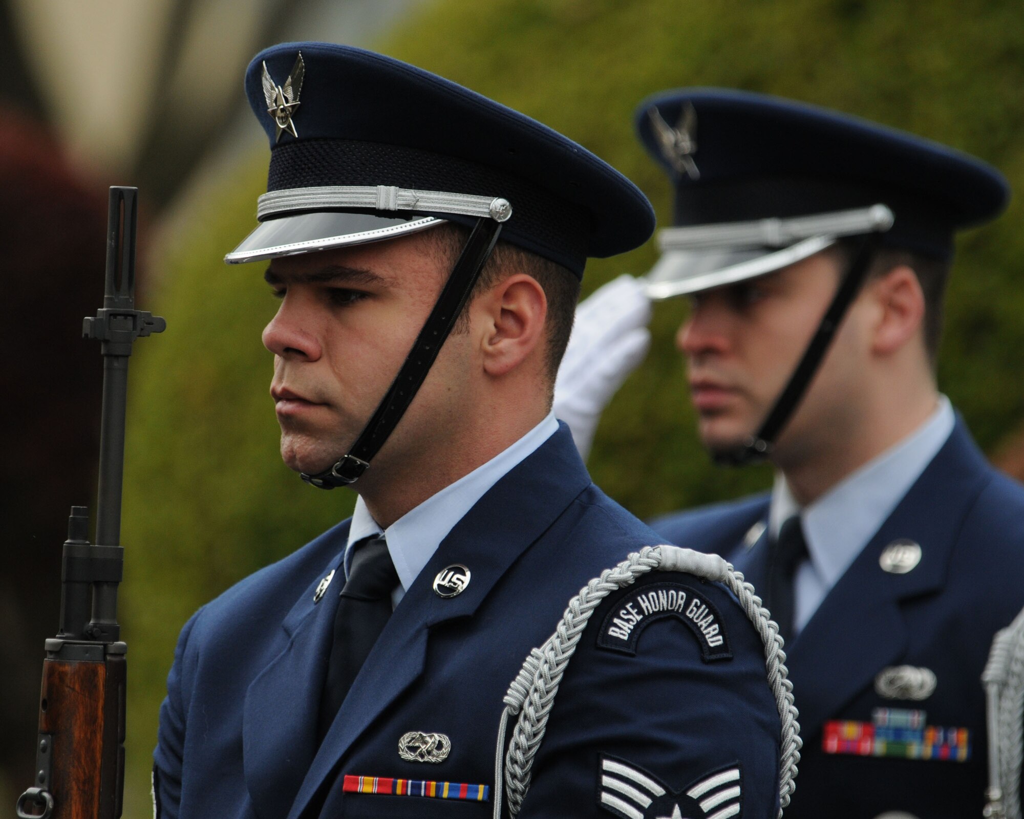 YOKOTA AIR BASE, Japan -- Yokota Air Base Honor Guard member Senior Airman Dean Atwa (right), of the 374th Aircraft Maintenance Squadron, salutes the U.S. flag during one of two Veterans Day ceremonies held here Nov. 11.  Yokota's honor guard provided a five-gun salute during the ceremony. (U.S. Air Force photo by Senior Airman Brian Kimball)