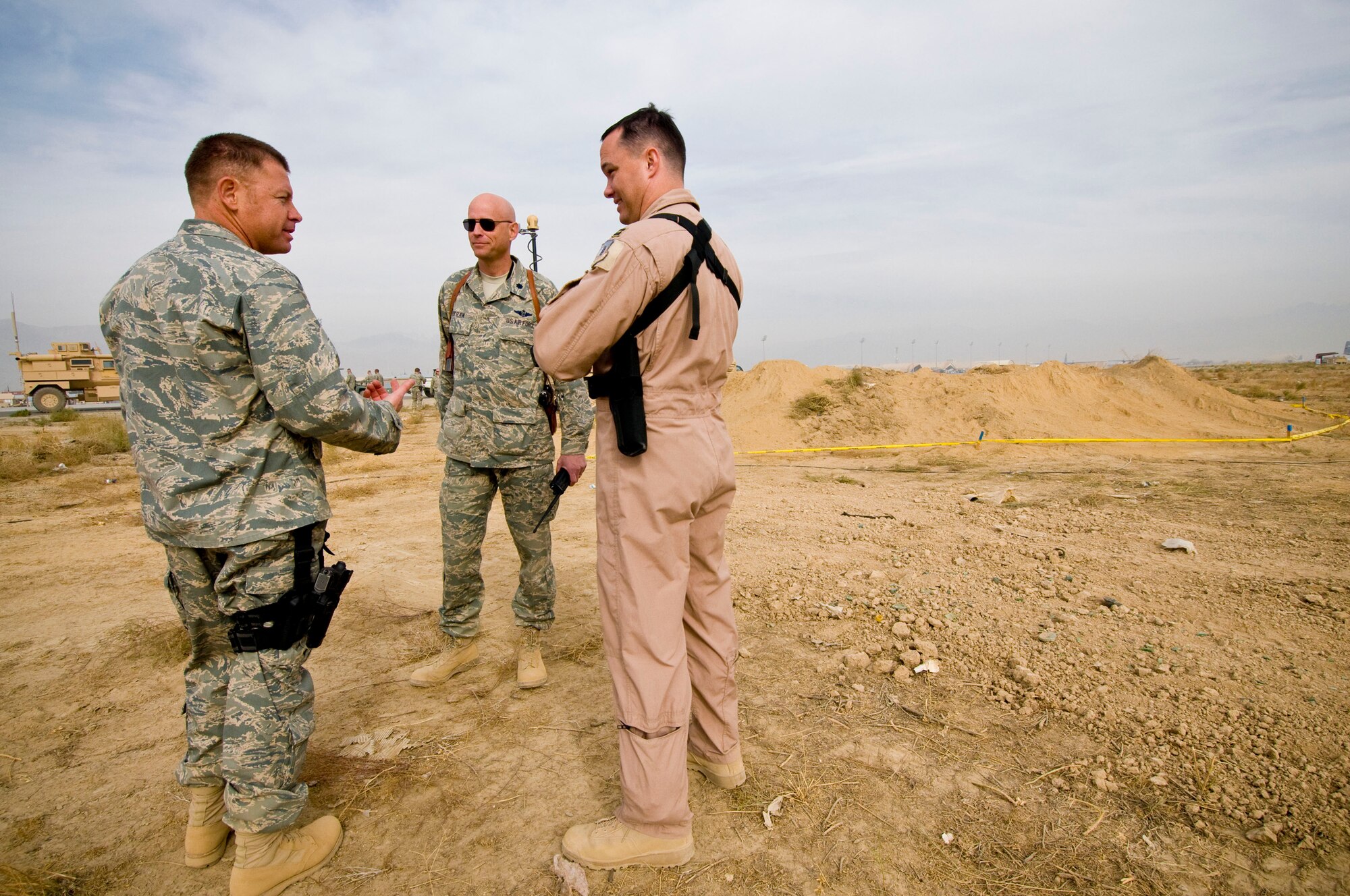 Lt. Col. Kevin Virts, Lt. Col. Wayne Straw and Capt. Michael Mayo of the 455th Expeditionary Operations Support Squadron make a post-action review of the controlled burn at Bagram Air Field, Afghanistan, Nov. 7. Colonel Virts and Captain Mayo successfully coordinated the evacuation of thousands of personnel and aircraft and the disposal of a Soviet OFAB 100 bomb weighing 220 pounds. (U.S. Air Force photo by Staff Sgt. Samuel Morse/Released)