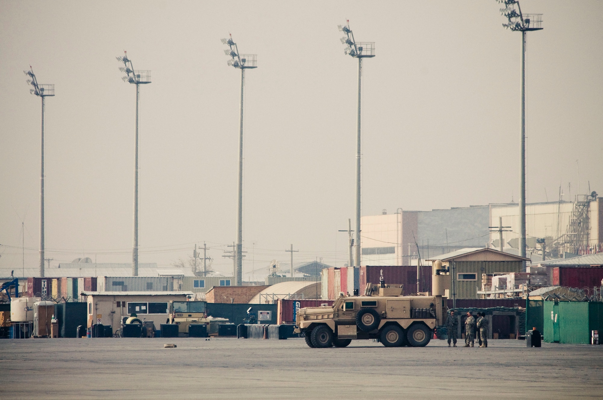 The 755th Air Expeditionary Group Explosive Ordinance Disposal team stands by at a safe distance from a controlled burn on the flightline at Bagram Air Field, Afghanistan, Nov. 7. The team waited until the smoke had completely cleared before approaching the extinguished Soviet bomb and gave the "all clear." (U.S. Air Force photo by Staff Sgt. Samuel Morse/Released)