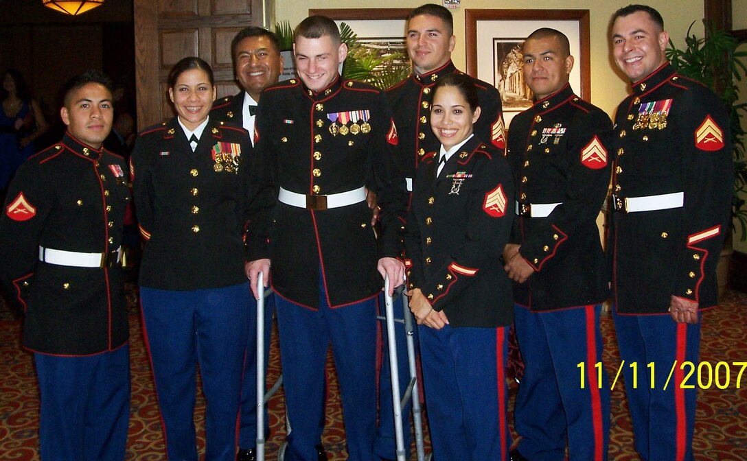 Marine Lance Cpl. Matthew Bradford, surrounded by fellow Marines, attends the Marine Corps Birthday Ball on Nov. 11, 2007, just 10 months after a roadside bomb blast cost him both legs and his sight.  Marine Corps photo by Lance Cpl. Matthew Bradford