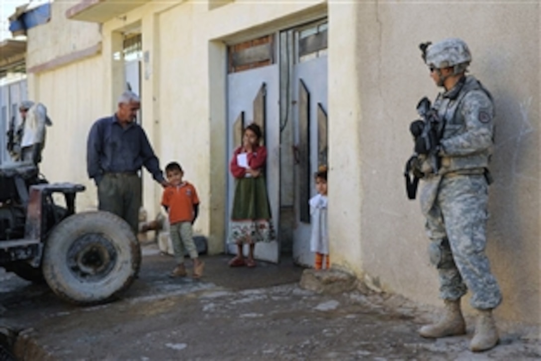 U.S. Army Sgt. Henry Murphy provides overwatch security for Iraqi National Police officers conducting a cordon and "knock" mission to introduce themselves to the residents of the Thawra neighborhood of Mosul, Iraq, Nov. 8, 2008. The soldiers are assigned to the 3rd Armored Cavalry Regiment's 3rd Squadron. 