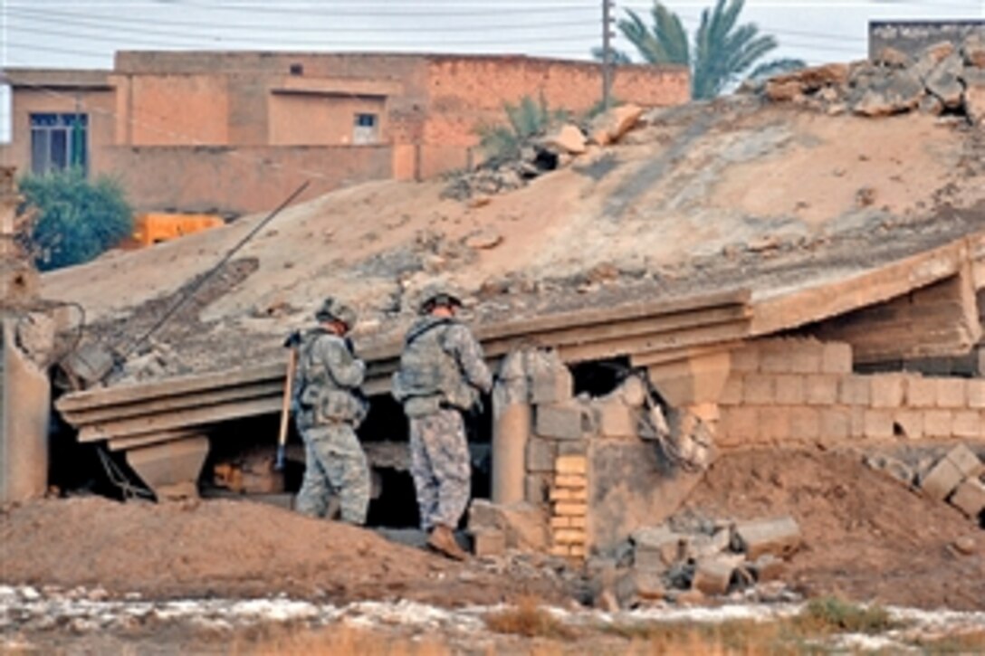 U.S. Army soldiers search the outside remains of a destroyed building in Muqdadyah, Iraq, Nov 4, 2008. The soldiers are assigned to the 1st Stryker Brigade Combat Team, 25th Infantry Division. The team is partnering with the Iraqi Army to clear the Muqdadyah area and disrupt Al-Qaeda networks and weapons caches in and around the Muqdadyah area.