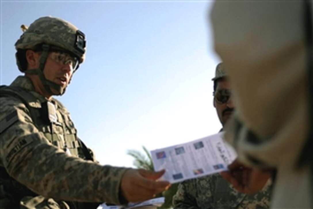 U.S. Army 2nd Lt. Joshua Christian distributes flyers and meets with local Iraqis in Diwaniyah, Iraq, Nov. 7, 2008. Christian and fellow soldiers are assigned to the 2nd Battalion, 8th Infantry Regiment, 4th Infantry Division. The flyers included information about cholera and wanted insurgents. 
