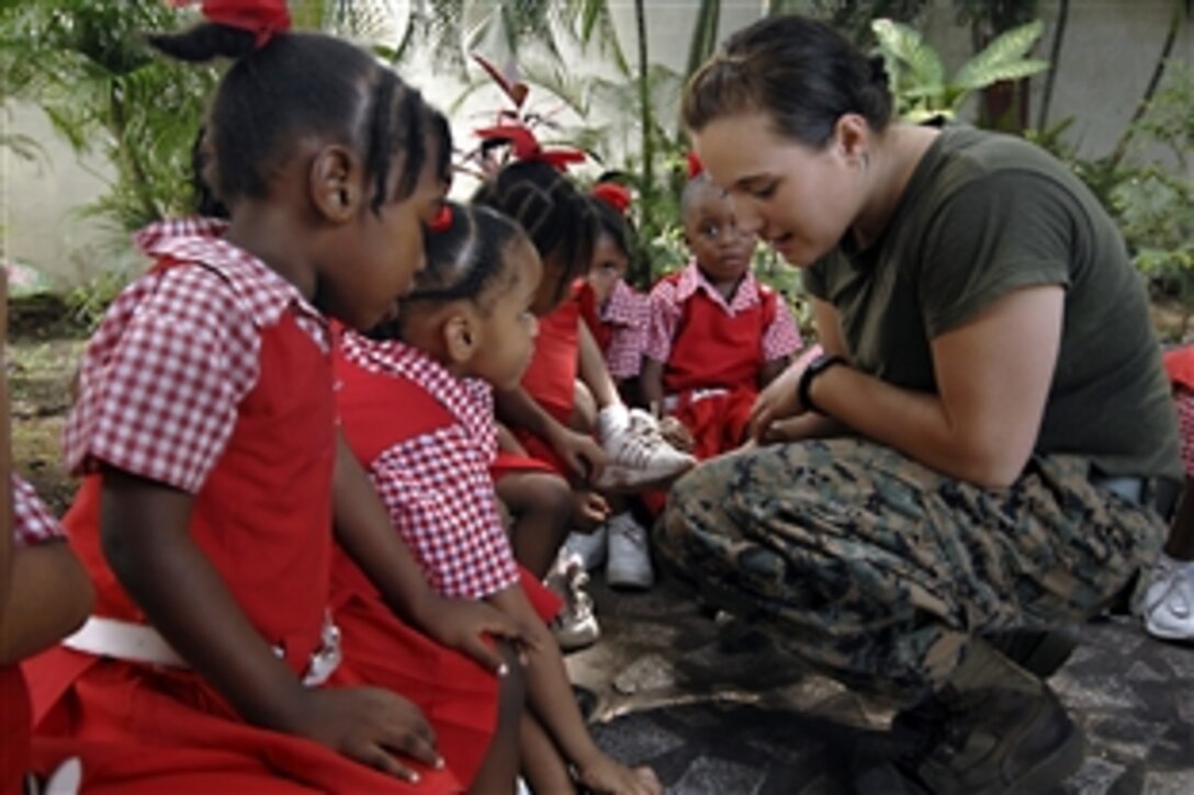 U.S. Marine Corps Lance Cpl. Mary Hojek uses her lunch break to interact with children at the St. Jude's School for Girls during the humanitarian and civic assistance mission Continuing Promise 2008 in Port of Spain, Trinidad and Tobago, Nov. 5, 2008.  The Kearsarge is supporting the Caribbean phase of Continuing Promise 2008, an equal-partnership mission between the United States, Canada, the Netherlands, Brazil, Nicaragua, Colombia, Dominican Republic, Trinidad, Tobago and Guyana.