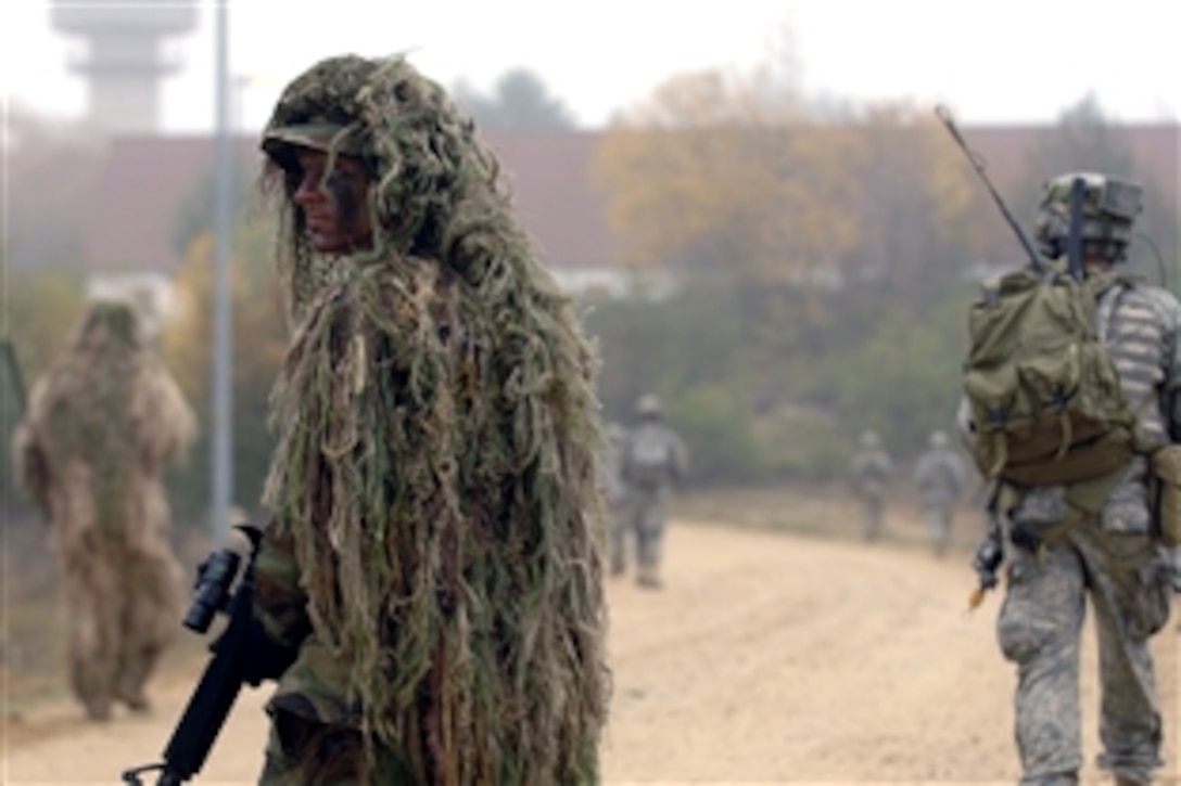 U.S. Army Spc. Alex Simpson, a sniper, provides rear cover for U.S. Air Force joint terminal air controllers in an urban warfare scenario during exercise Allied Strike II at Hohenfels Army Garrison, Germany, Nov. 6, 2008. Allied Strike II is a combined U.S. and coalition forces exercise that trains joint terminal attack control members in preparation for deployments in support of Operation Iraqi Freedom and Operation Enduring Freedom.