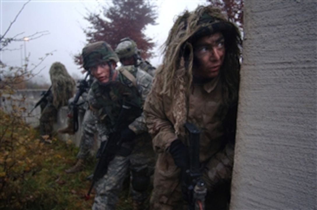 U.S. Army Spc. Nicholas Ranstad (right), a sniper, leads a fire team of Air Force joint terminal air controllers in search of a high-value target during an exercise in support of Allied Strike II at U.S. Army Garrison Hohenfels, Germany, on Nov. 6, 2008.  Allied Strike II is a combined U.S. and coalition forces exercise that trains joint terminal attack control members in preparation for deployments in support of Operations Iraqi and Enduring Freedom.  