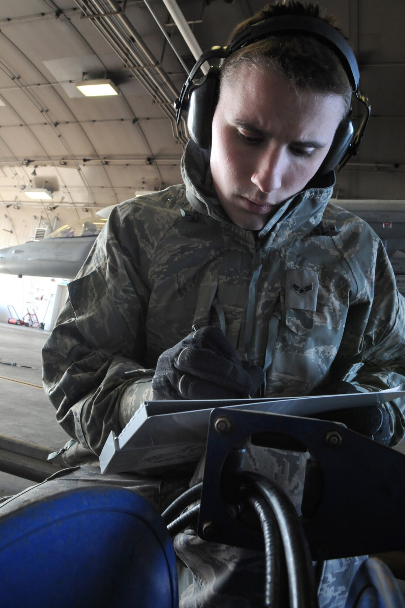 MISAWA AIR BASE, Japan -- Airman 1st Class Casey Kubik, 35th Logistics Readiness Squadron refueling operator, documents data after the hot-pit refueling of an F-16, Nov. 18, 2008. During the operation, Airman Kubik was known as the "C-man," whose job was to monitor fuel flow. (U.S. Air Force photo by Airman 1st Class Jamal D. Sutter) 