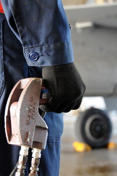 MISAWA AIR BASE, Japan -- Staff Sgt. Michael Botti, 35th Aircraft Maintenance Squadron crew chief, operates a "dead man," during the hot-pit refueling of an F-16, Nov. 10, 2008. The dead man is a tool used to start and stop fuel flow to the aircraft. (U.S. Air Force photo by Airman 1st Class Jamal D. Sutter)