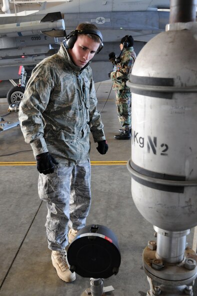 MISAWA AIR BASE, Japan -- Airman 1st Class Casey Kubik, 35th Logistics Readiness Squadron refueling operator, monitors fuel pressure during the hot refueling of an F-16, Nov. 10, 2008. During the procedure, Airman Kubik served as the refuel equipment operator or "C-man." (U.S. Air Force photo by Airman 1st Class Jamal D. Sutter)