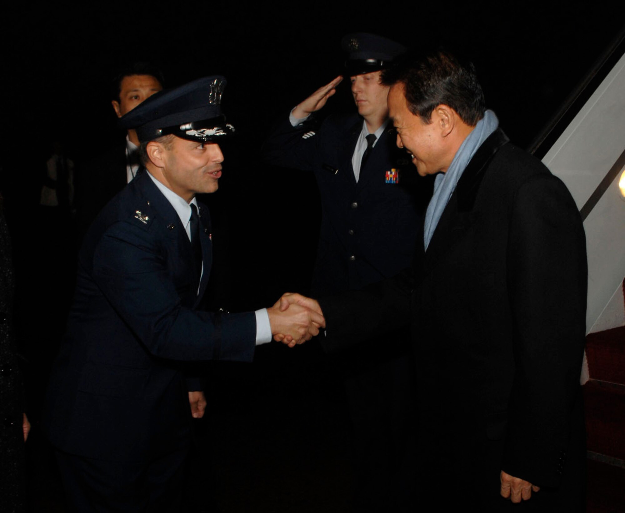 Colonel Eric A. Snadecki, 316th Wing vice commander, greets Japanese Prime Minister Taro Aso at Andrews Air Force Base, Md., Nov.13, 2008, for the two-day G20 Summit at the White House in Washington.  The summit, hosted by U.S. President George W. Bush, will bring together world leaders to discuss the increasing global financial crisis, its causes and efforts to resolve it.  (U.S. Air Force photo by Tech. Sgt. Craig Clapper)