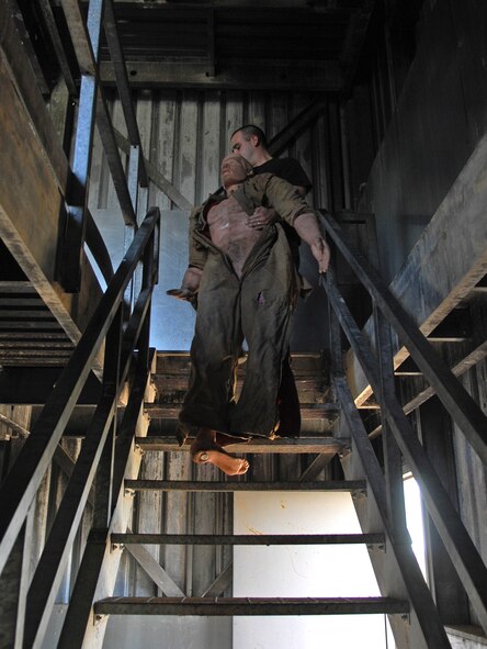 BARKSDALE AFB, LA---Airman Darren Henderson moves a 200 pound "victim" to the second floor of a simulated burning building during training on Sept. 30, 2008. (USAF Photo by Staff Sgt. Trina R. Jeanjacques)(Released)