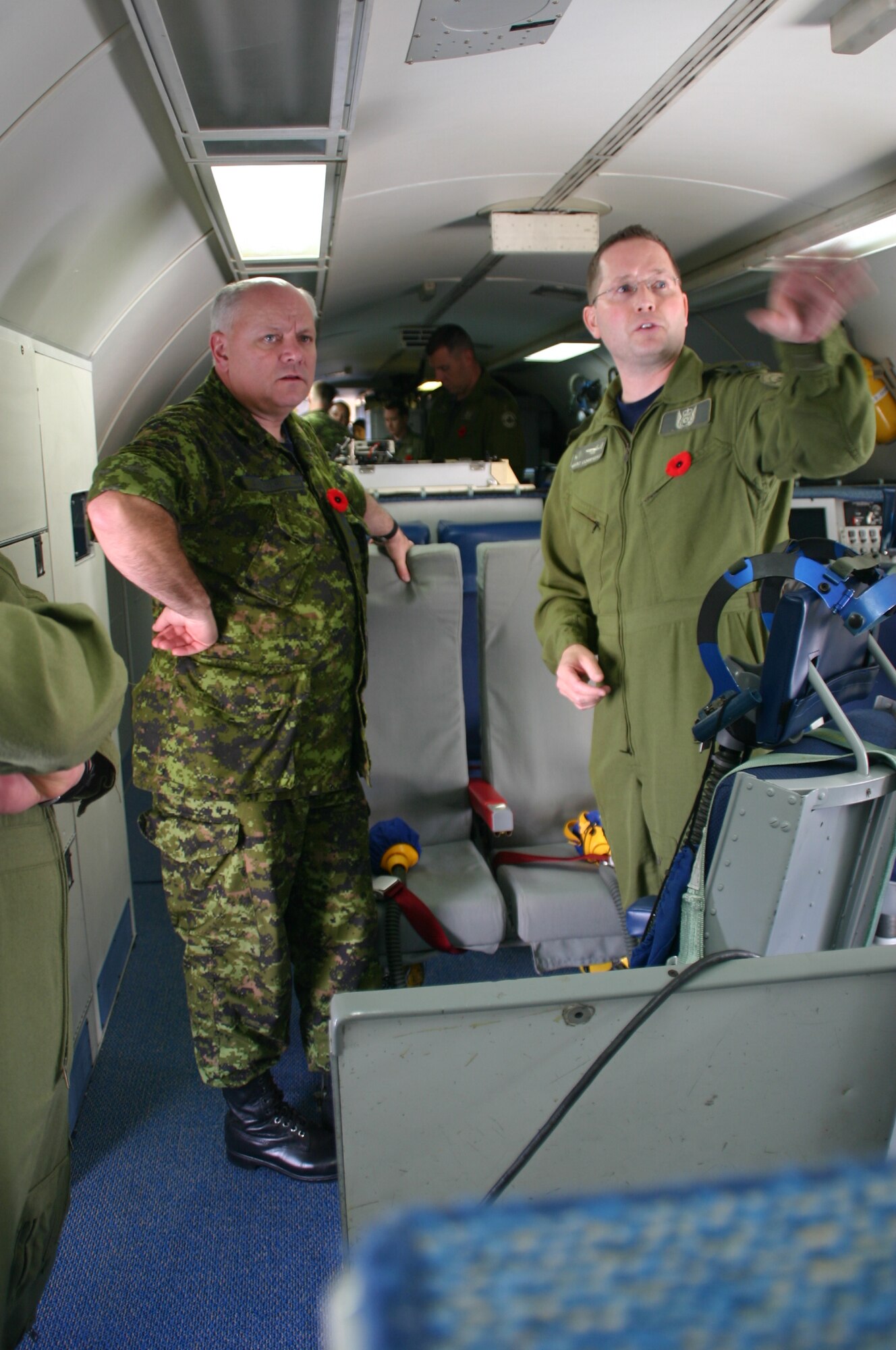 Canadian Warrant Officer Marc Corriveau, of the 552nd Operations Support Squadron, explains his role with the AWACS to Lt. Gen. J.J.C. “Charlie” Bouchard, deputy commander of North American Aerospace Defense Command. (Air Force photo/1st Lt. Kinder Blacke)