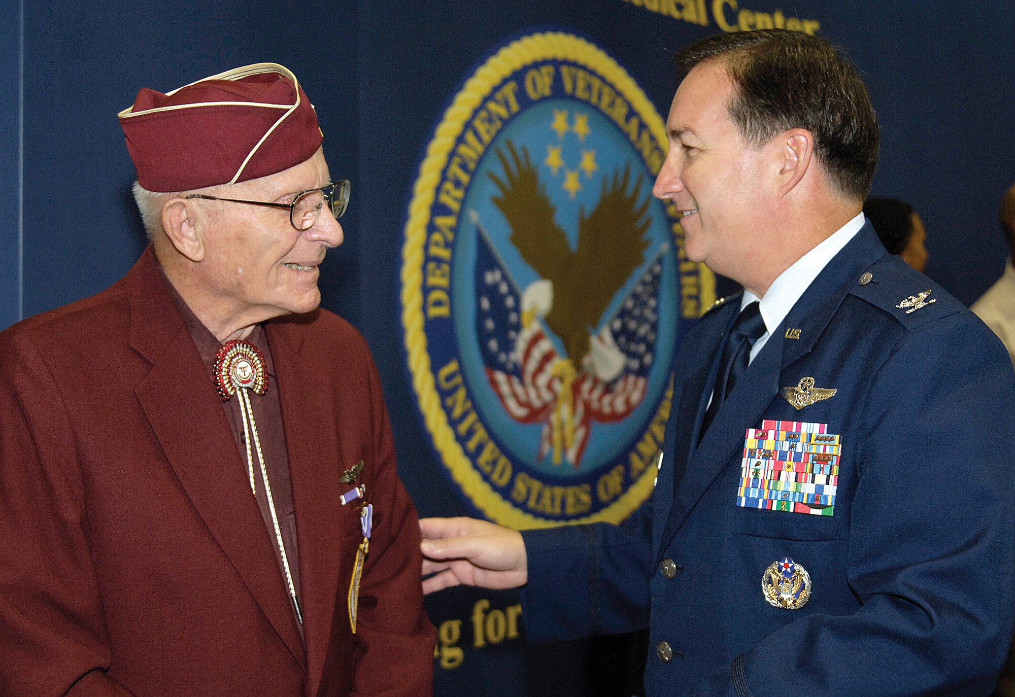 World War II veteran and ex-prisoner of war Delbert Coulter visits with Col. Joseph Rossacci, 552nd Air Control Wing vice commander, after a Veterans Day program Nov. 10 at the Veterans Affairs Medical Center in Oklahoma City. The B-24 flight engineer and top turret gunner told of being shot down and his 14-month imprisonment during a bitterly cold German winter. Repeated “thank yous” from Tinker Airmen and others attending the program brought tears to the veteran’s eyes who said memories of his service are still fresh in his mind. (Air Force photo/Margo Wright)