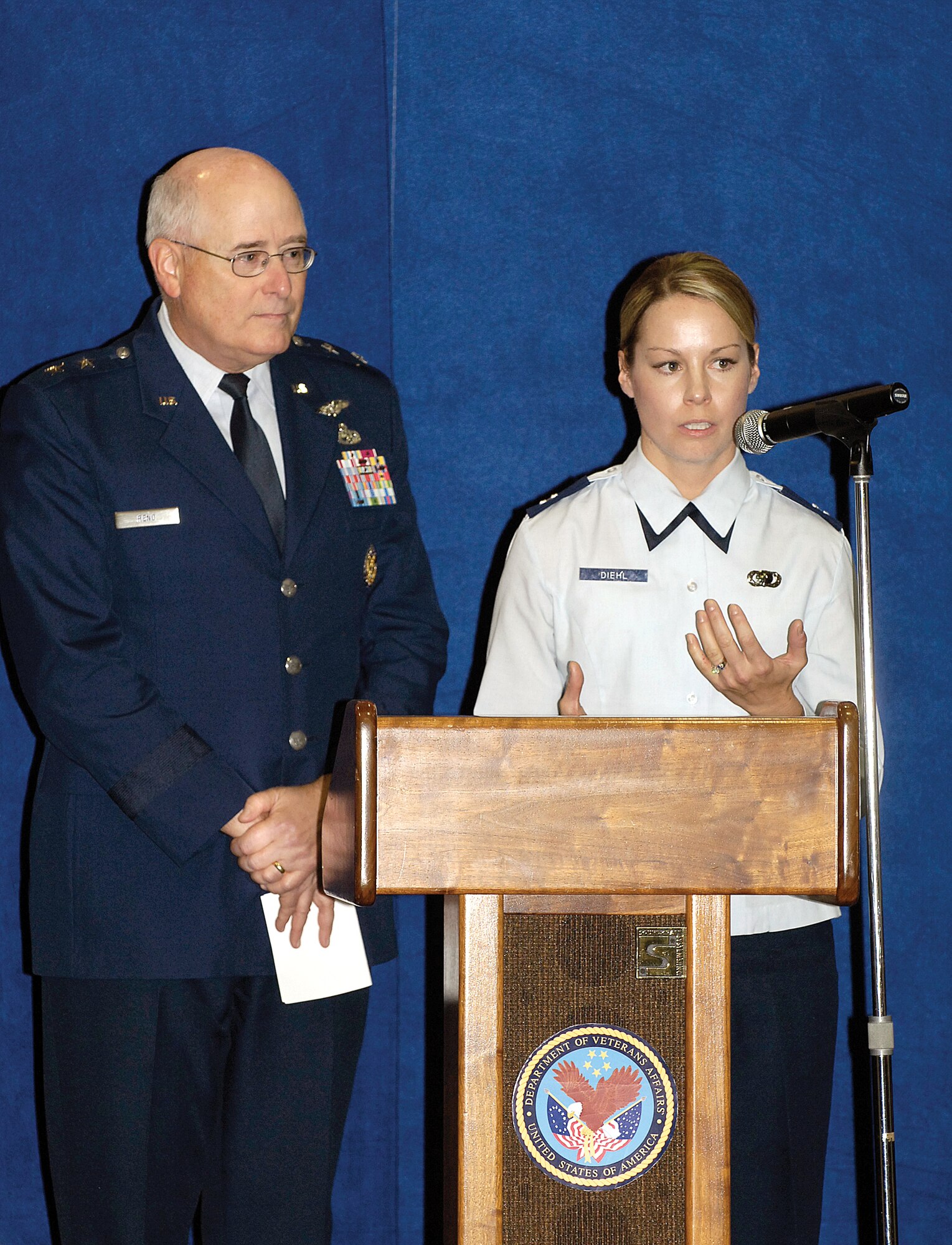 Maj. Gen. Loren Reno listens to Capt. Virginia Diehl describe her recent deployment to the Green Zone in Iraq during a Nov. 10 Veterans Day program at the Oklahoma City Veterans Affairs Medical Center.  The Oklahoma City Air Logistics Center commander was the featured speaker but brought four military members on stage to share their experiences with an auditorium full of people. The general thanked veterans for their sacrifices and service and greeted ex-prisoners of war and veterans after the program. (Air Force photo/Margo Wright)