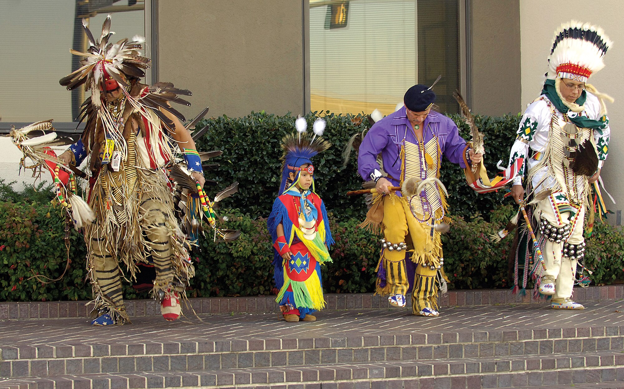 Native American singing and drumming are the background for dancers after a retreat ceremony Nov. 4 in front of Bldg. 460.  From left; Eddie Two Clouds Zermeno, four-year-old Isaiah Patterson, Walter Chrysler and Eastman Switch, who works in the 76th Maintenance Wing’s plating shop.(Air Force photo/Margo Wright)