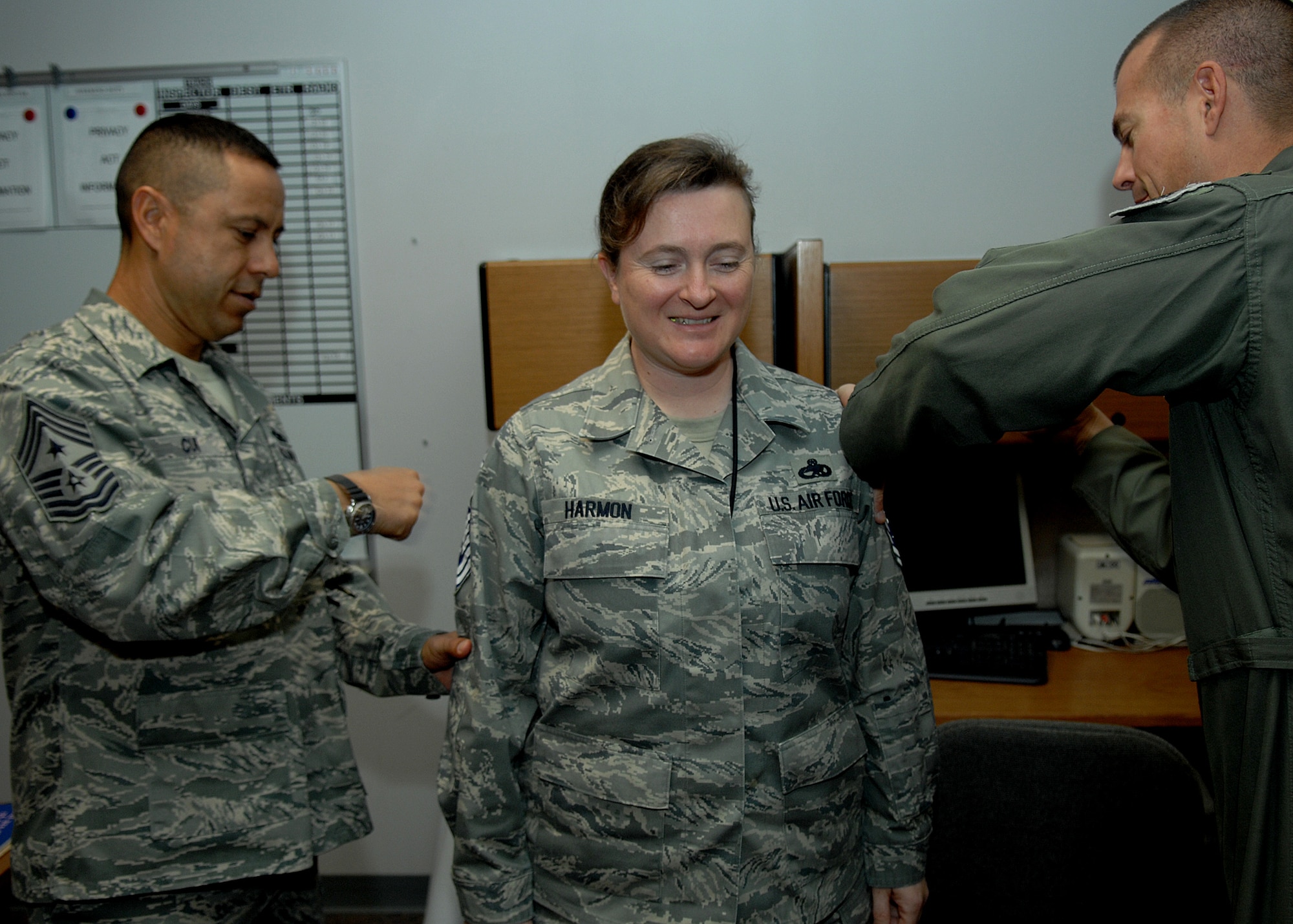 Senior Master Sgt. Kathleen Harmon, 49th Aircraft Maintenace Squadron, recieves notification of her promotion to Chief Master Sergeant by Col. Michael McGee, 49th Fighter Wing vice commander and the 49 FW Command Chief, Chief Master Sgt. Jeffery Cui, Nov. 11 at Holloman Air Force Base, N.M. The Air Force recently announced the names of 520 Senior Master Sergeants who were selected for promotion to Chief Master Sergeant. (U.S. Air Force photo/ Senior Airman Anthony Nelson)