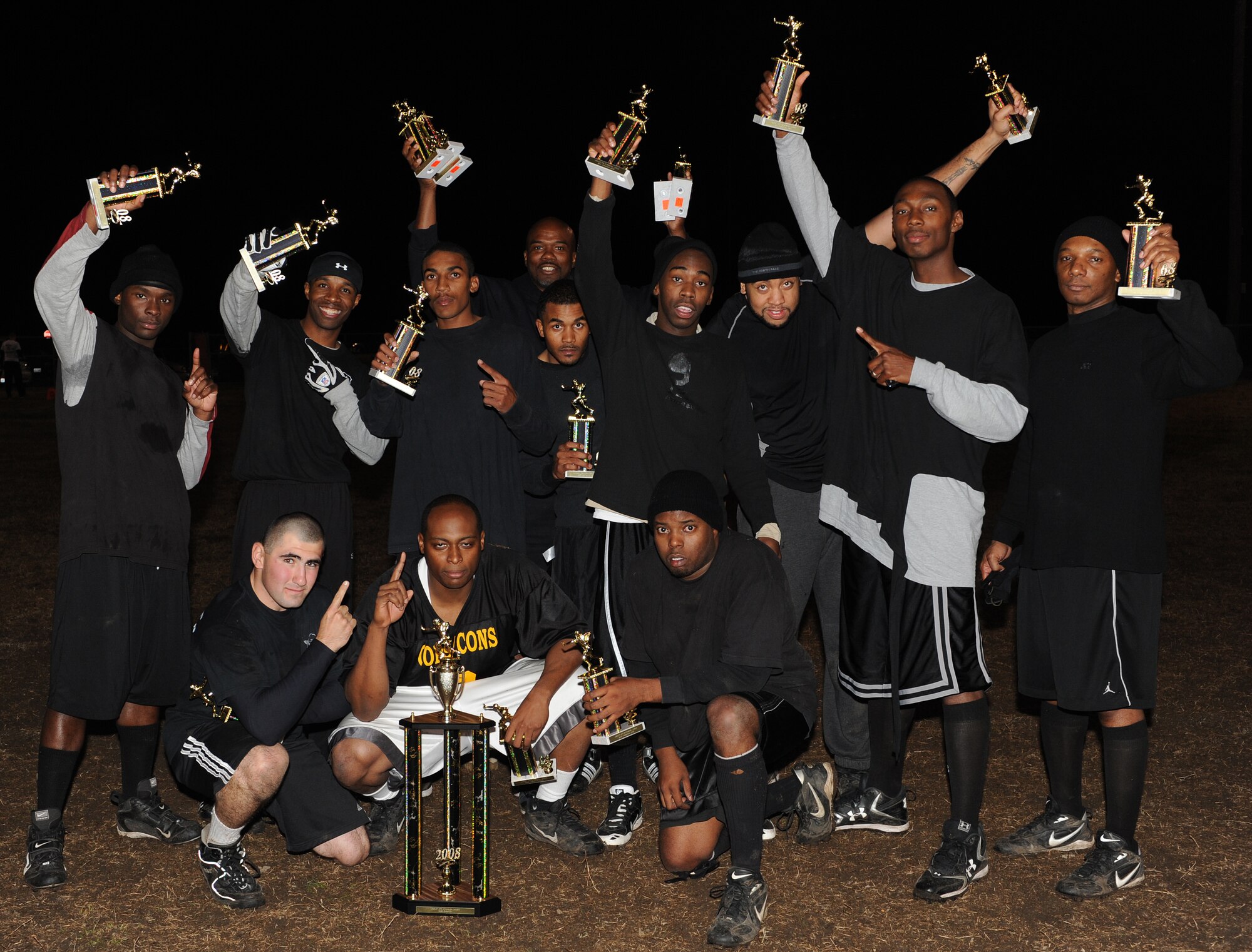 LANGLEY AIR FORCE BASE, Va. -- The 1st Security Forces Squadron Defenders raise their trophies in victory Nov. 10.  The Defenders beat the 1st Equipment Squadron Bulldogs 14 to 6 to take the 2008 Intramural Flag Football Championship.  (U.S. Air Force photo/Airman 1st Class Zachary Wolf)