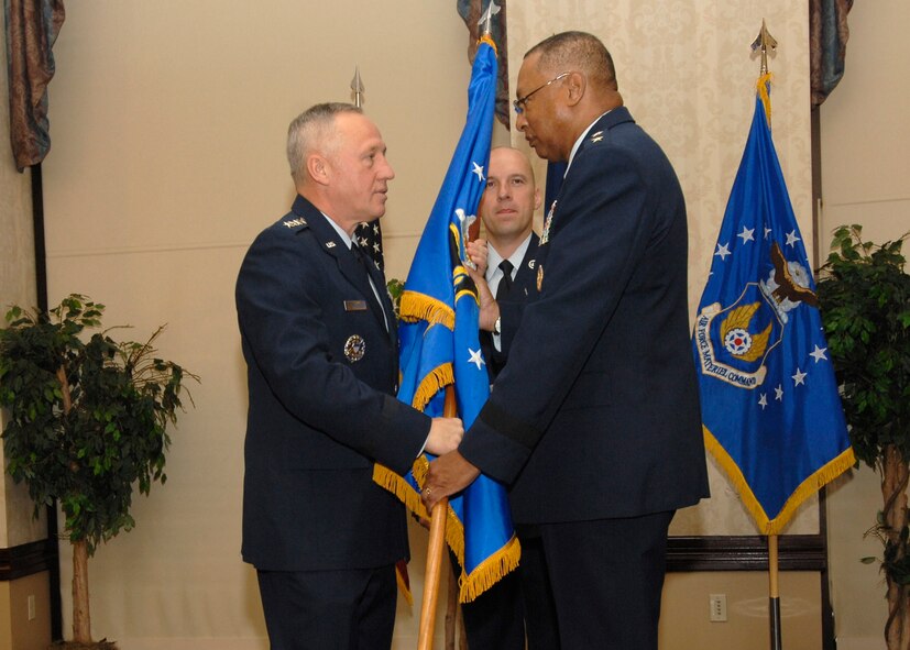 Gen. Bruce Carlson, Air Force Materiel Command commander, passes command of the Air Force Global Logistics Support Center forward to Maj. Gen. Gary T. McCoy during a change of command ceremony at Scott Air Force Base, Ill., Nov. 13. (U.S. Air Force photo by Tech. Sgt. Michelle Larche)
 