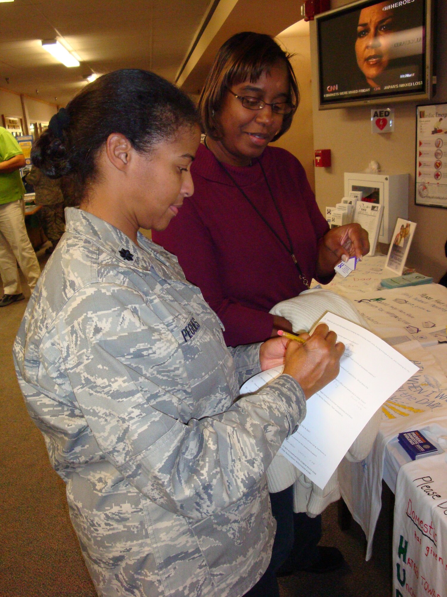 WRIGHT-PATTERSON AIR FORCE BASE, Ohio (AFMCNS) -- Lt. Col. Lisa Pegues, Air Force Materiel Command Public Health chief, talks with Luchawna Givner, administrative services assistant, during AFMC headquarters' Wingman Wellness Day Fair held Oct. 31.  The event -- which was designed to focus on the physical, spiritual, emotional and social facets of wellness -- was part of a headquarters-wide spotlight on Airmen helping Airmen every day of the year.  In addition to the fair, individual units throughout AFMC dedicated time to further building professional relationships between co-workers, and focusing on how to best take care of each other through good times and bad. (U.S. Air Force photo by Capt. Bob Everdeen) 