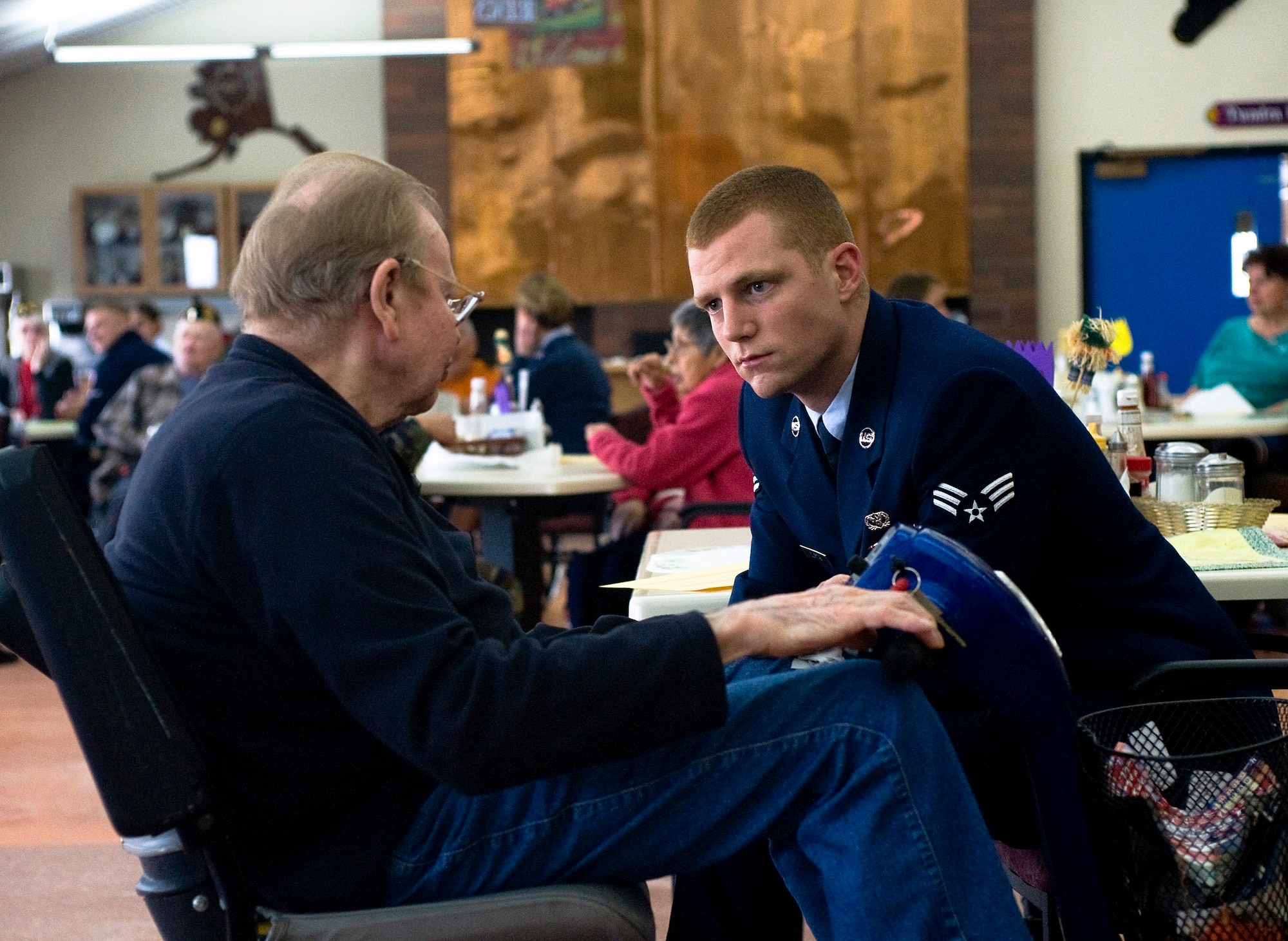 ANCHORAGE, Alaska -- Senior Airman David Curtis, 3rd Civil Engineer Squadron, listens to a veteran at Anchorage Pioneer Home Nov. 7. Arctic Warriors spent some time with veterans to socialize and eat ice cream. (U.S. Air Force photo/Senior Airman Jonathan Steffen)