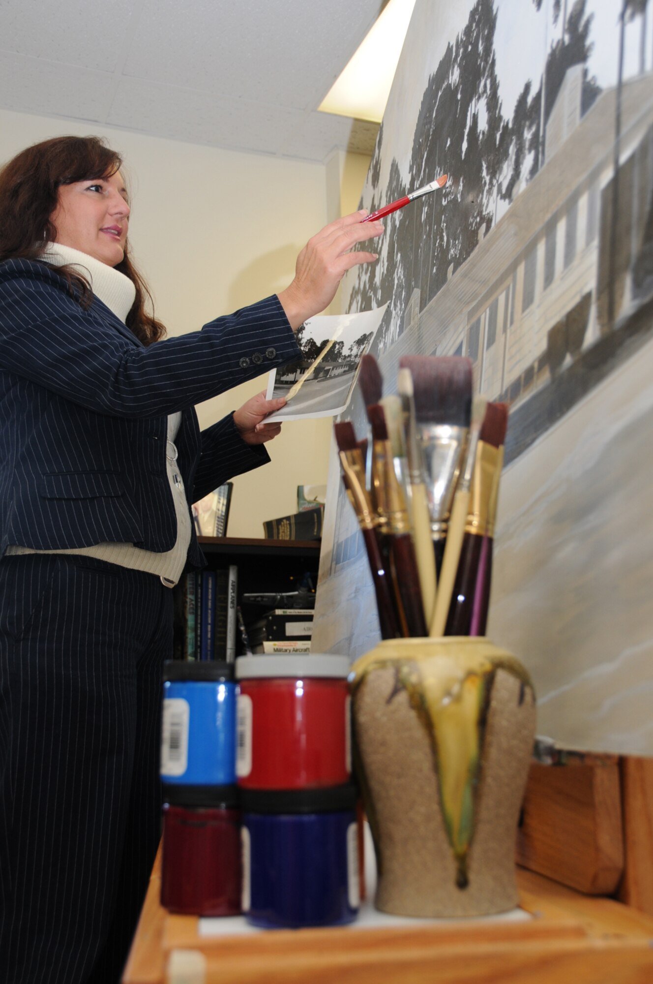 Suzy Templin, military fine artist, works on a painting for display at Keesler.  (U.S. Air Force photo by Kemberly Groue)