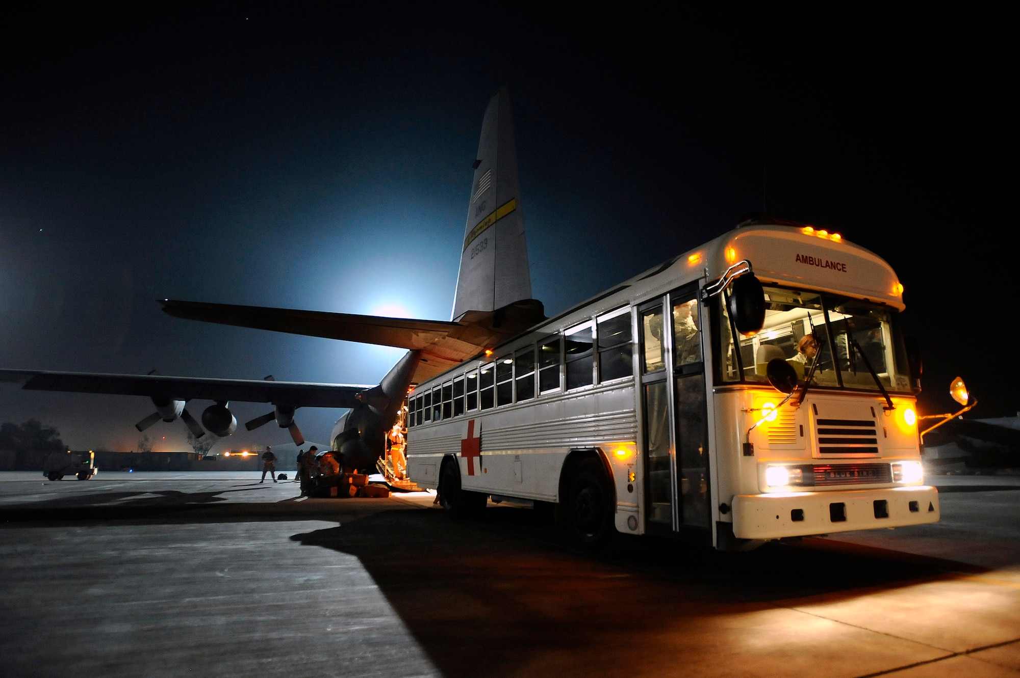 A bus from the Contingency Aeromedical Staging Facility at Joint Base Balad, Iraq, prepares to offload ambulatory and litter-bound patients from a C-130 Hercules Nov. 8. Two Iraqi doctors from Iraq's Ministry of Defense accompanied a Air Force aeromedical evacuation mission to study aeromedical evacuation procedures so that they can establish an aeromedical evacuation service for the Iraqi air force. (U.S. Air Force photo/Airman 1st Class Jason Epley)