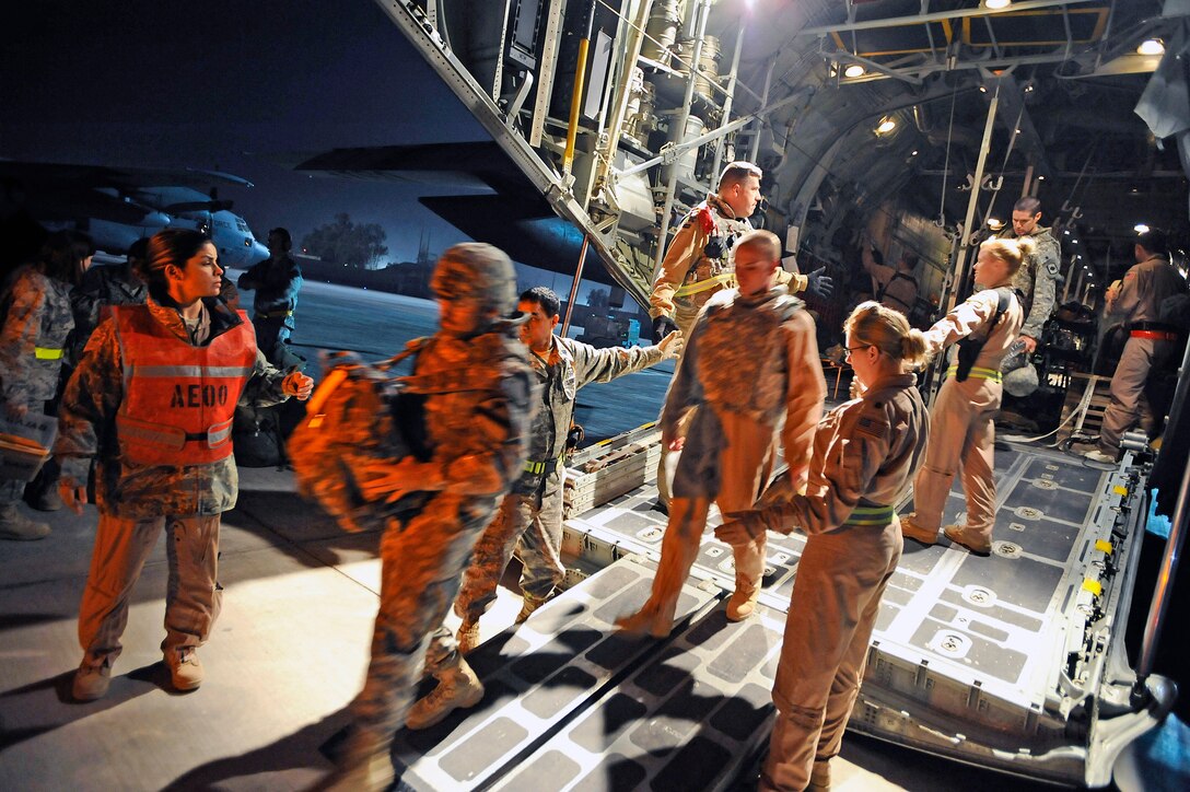 Ambulatory patients depart a C-130 Hercules assigned to the 777th Expeditionary Airlift Squadron at Joint Base Balad, Iraq, Nov. 8. Two Iraqi doctors from Iraq's Ministry of Defense accompanied an aeromedical evacuation mission to study Air Force aeromedical evacuation procedures so that they can establish an aeromedical evacuation service for the Iraqi air force. (U.S. Air Force photo/Airman 1st Class Jason Epley)