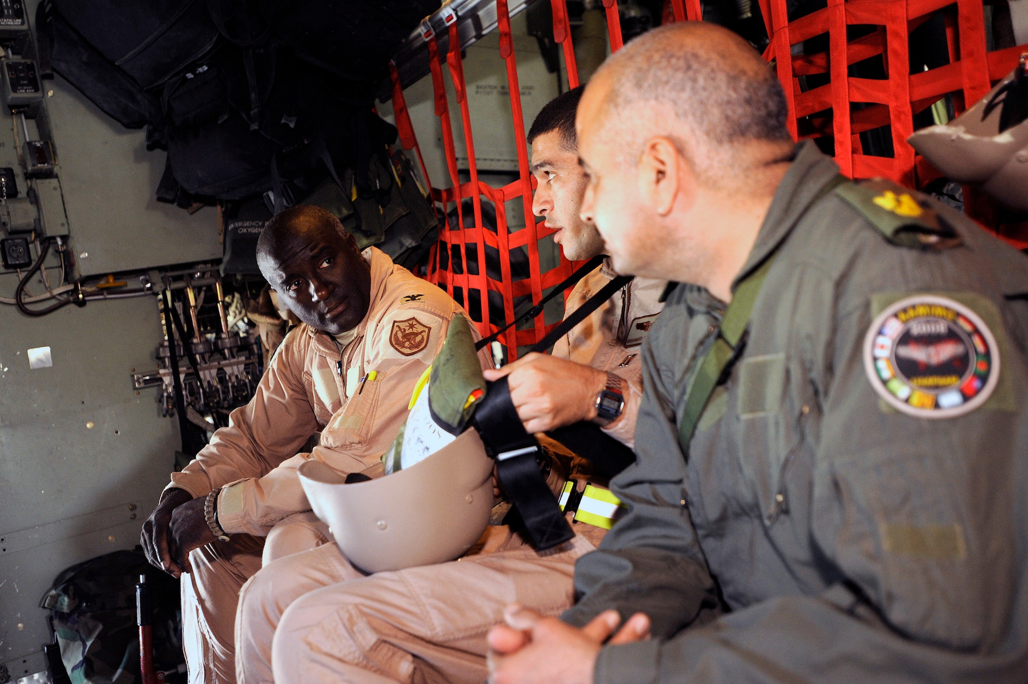 Col. (Dr.) Paul Young converses with Iraqi air force Capt. (Dr.) Mohammed and Iraqi air force Maj. (Dr.) Abdul-Razaq before departing on an aeromedical evacuation mission over Iraq Nov. 7. The two Iraqi doctors from Iraq's Ministry of Defense accompanied the Air Force mission to study aeromedical evacuation procedures so that they can establish an aeromedical evacuation service for the Iraqi air force. Doctor Young, the surgeon general for the Coalition Air Forces Transition Team, is deployed from Ramstein Air Base, Germany. (U.S. Air Force photo/Airman 1st Class Jason Epley)