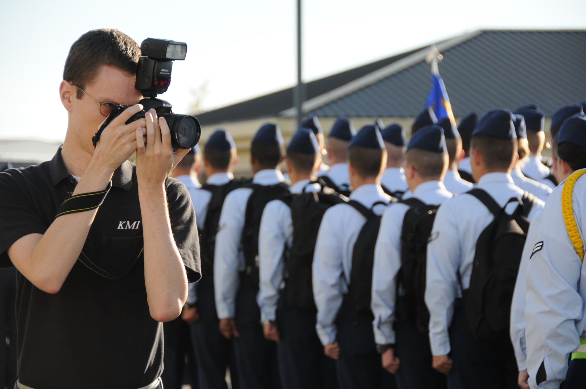 Photographer Adam Bond takes shots of students from the 335th Training Squadron outside of Wolfe Hall.  (U.S. Air Force photo by Kemberly Groue)