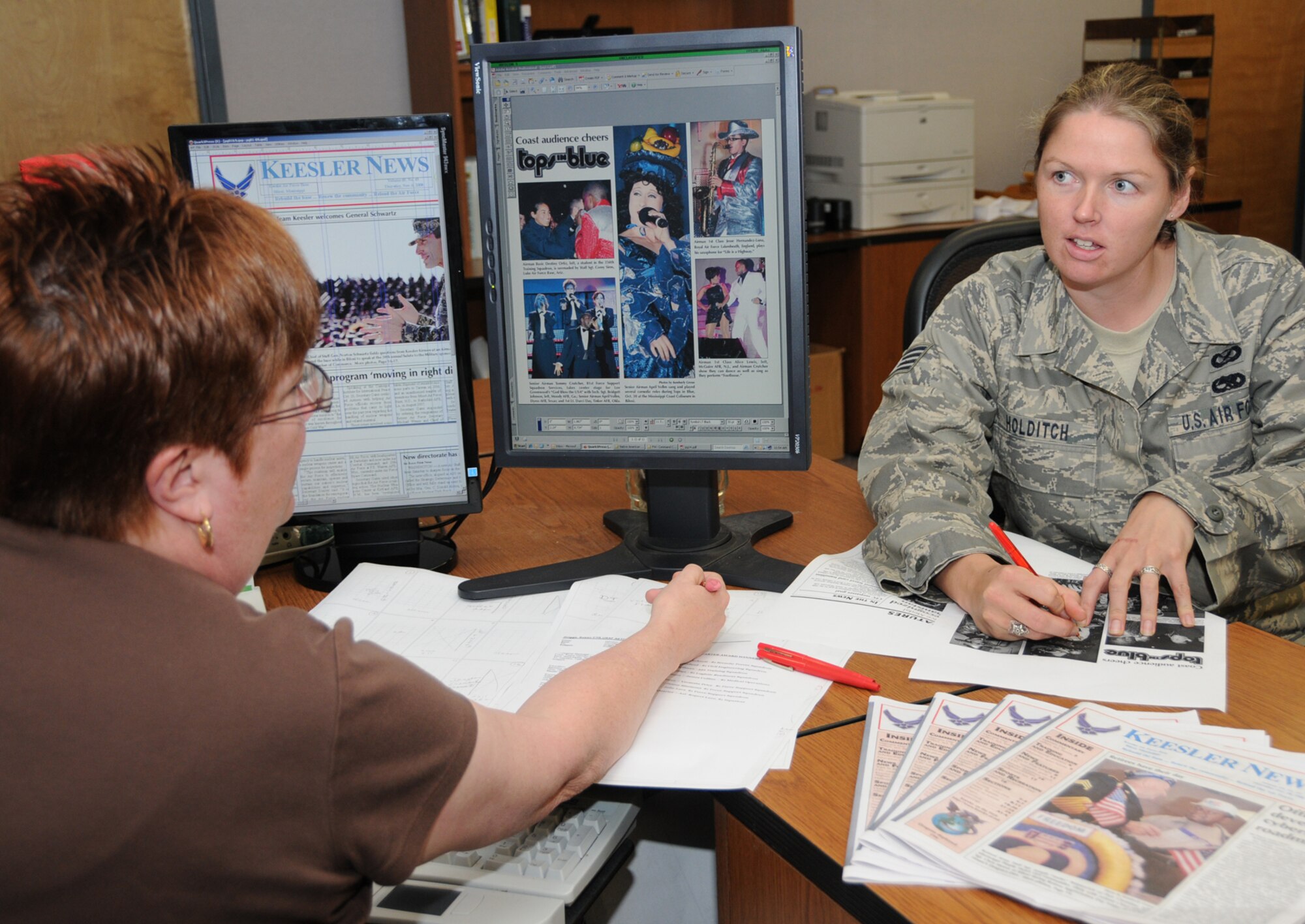 Susan Griggs, left, and Staff Sgt. Tanya Holditch, Keesler News editor, plan layouts for the weekly base newspaper. Ms. Griggs works for The Sun Herald, contract publisher of the Keesler News.  (U.S. Air Force photo by Kemberly Groue)